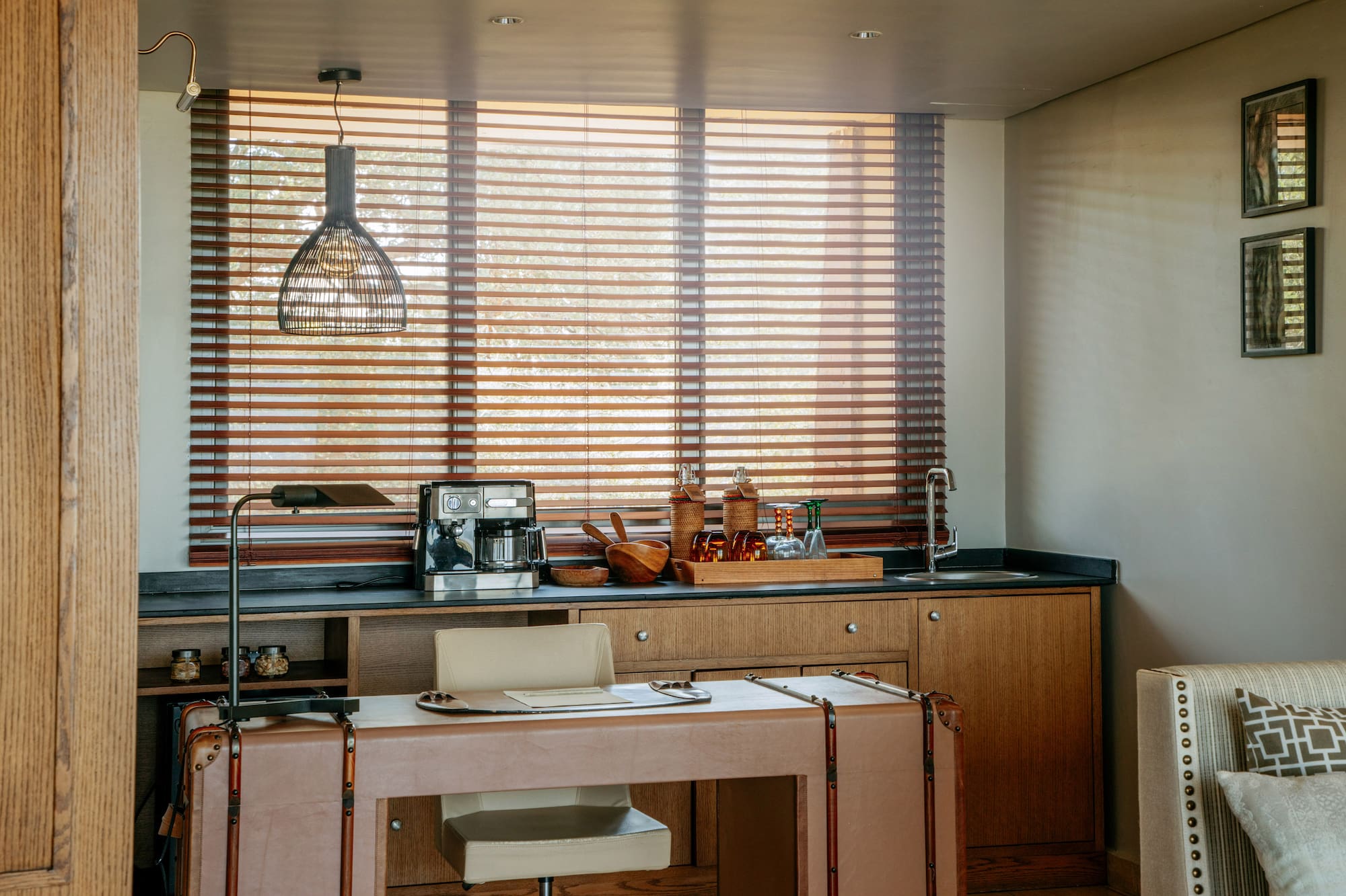 Home office and wet bar with coffee station, leather desk, wooden blinds.