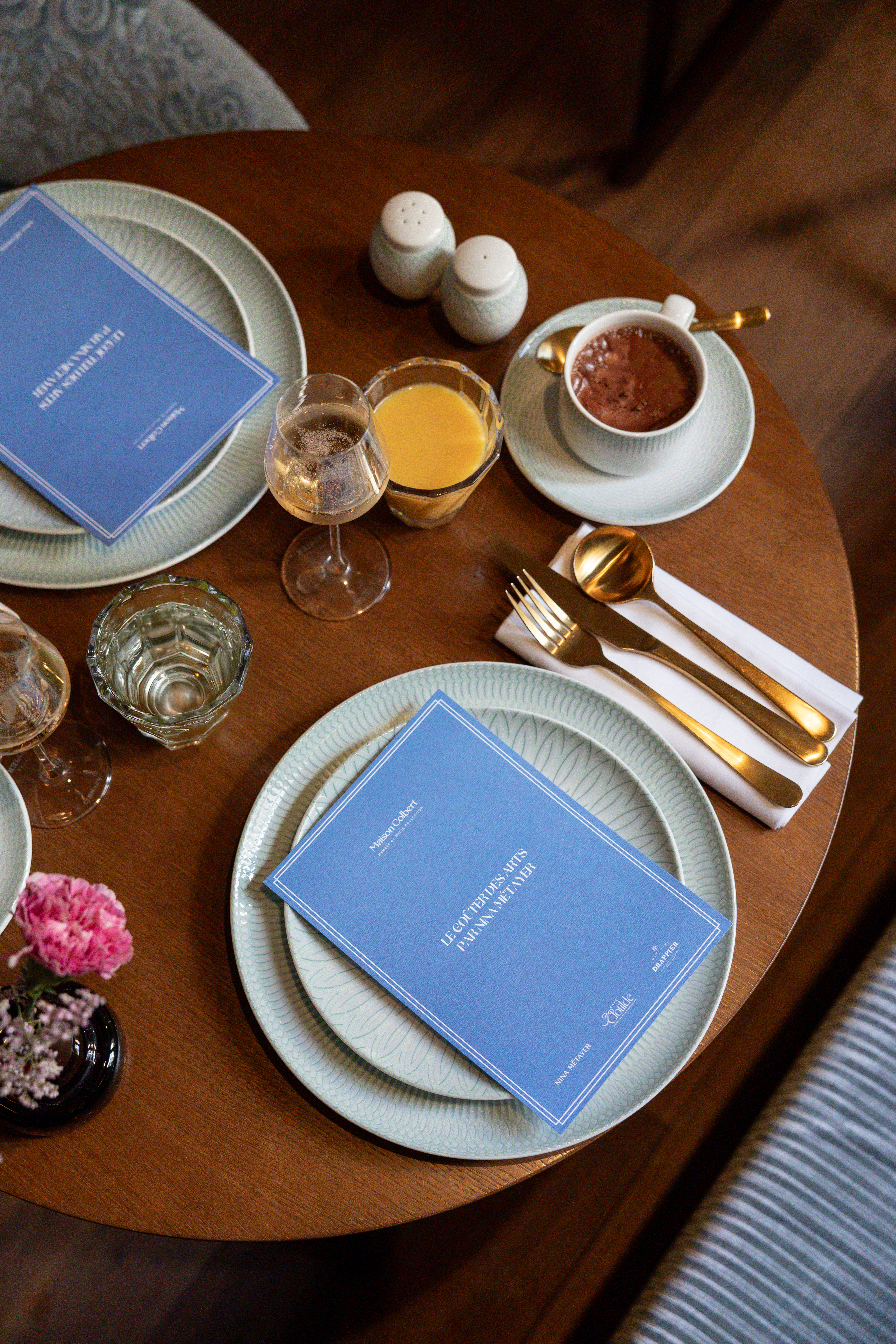 a table with plates and glasses and utensils