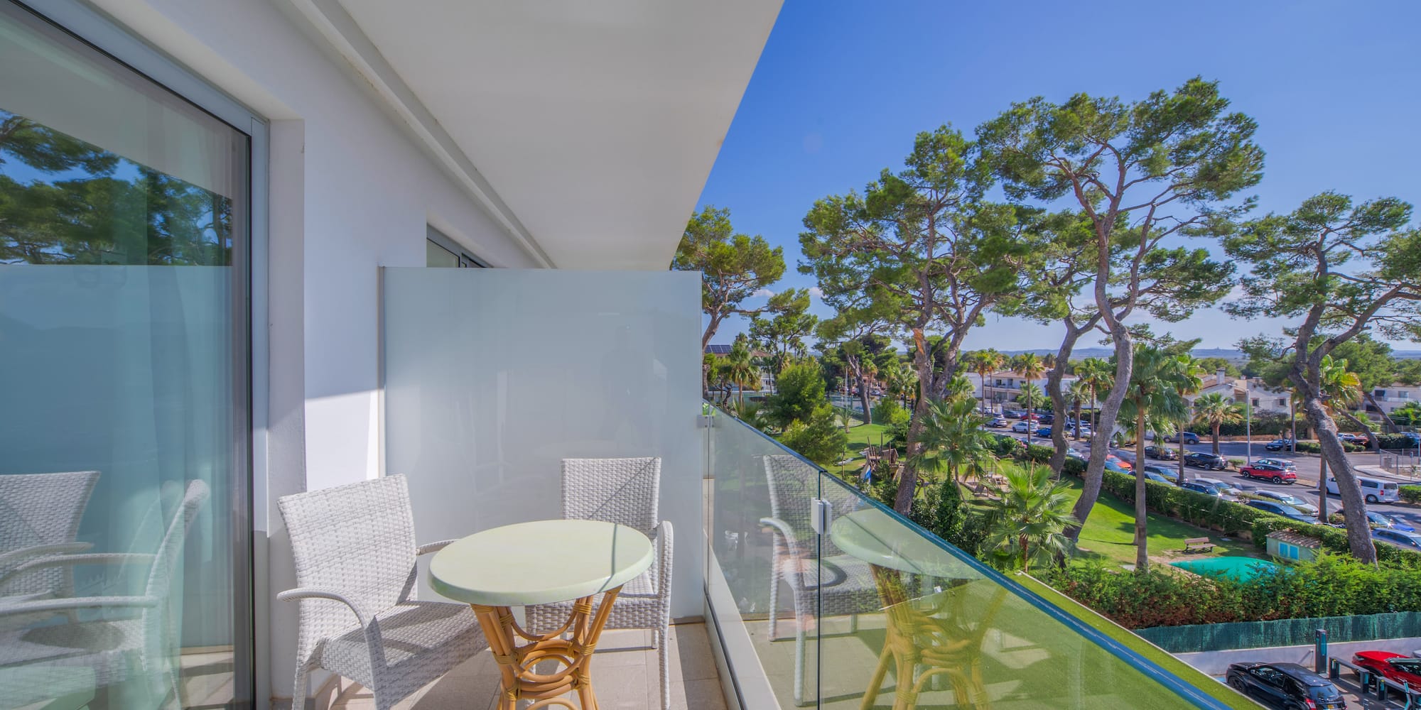 a balcony with a table and chairs