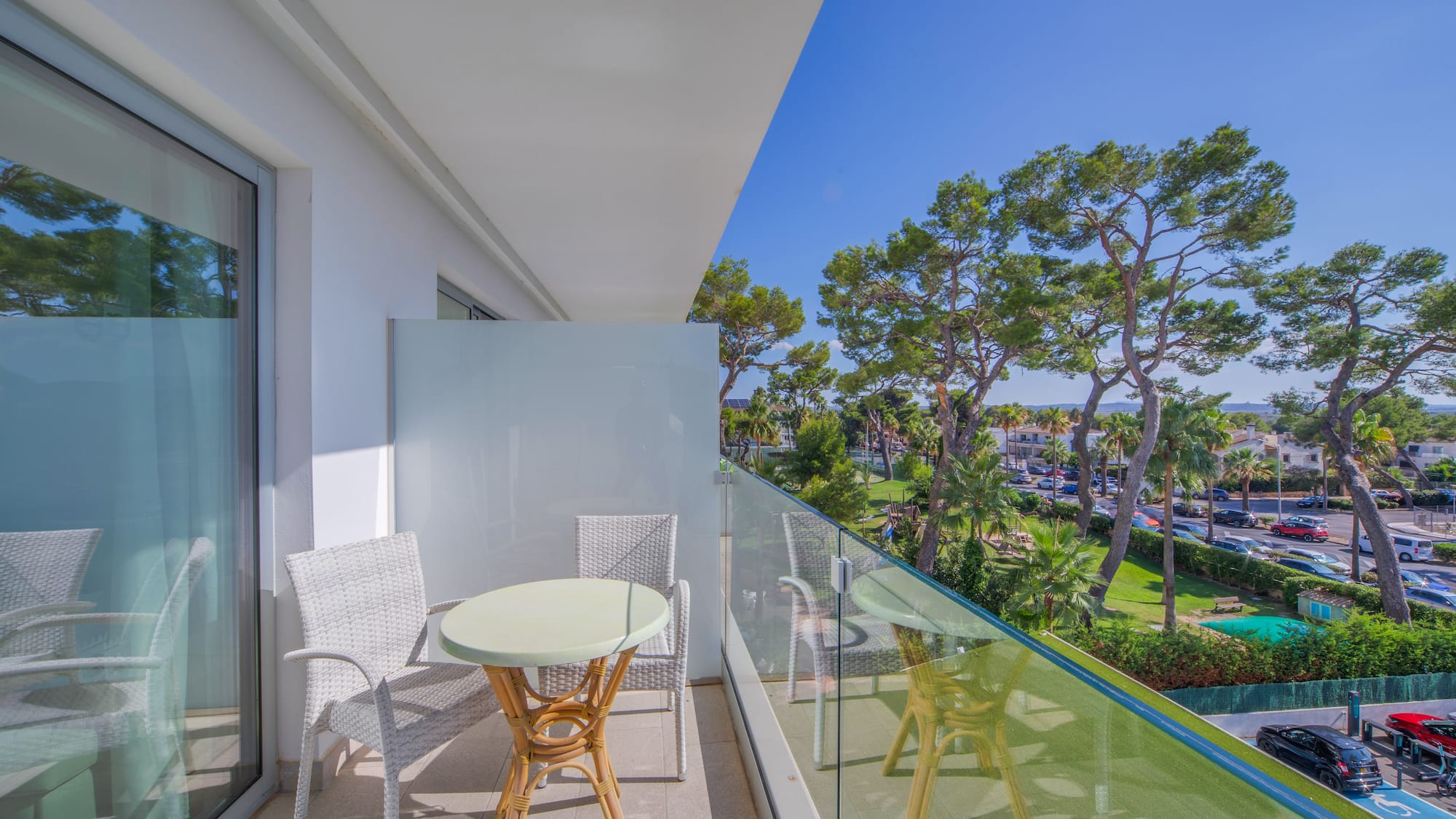 a balcony with a table and chairs