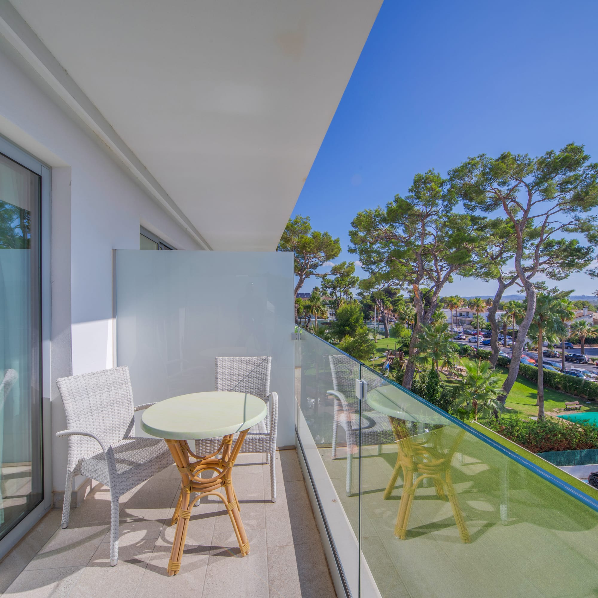 a balcony with a table and chairs