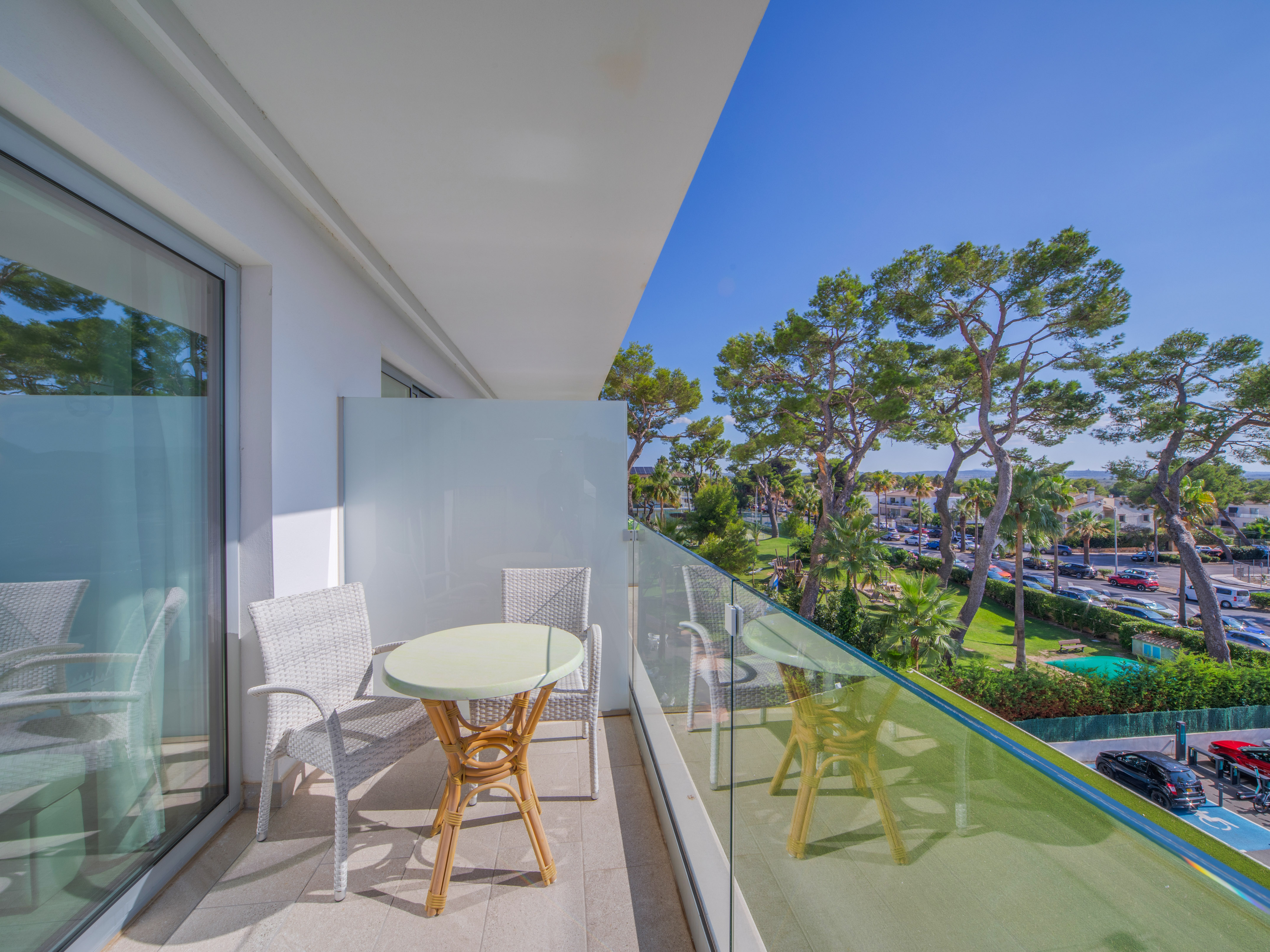 a balcony with a table and chairs