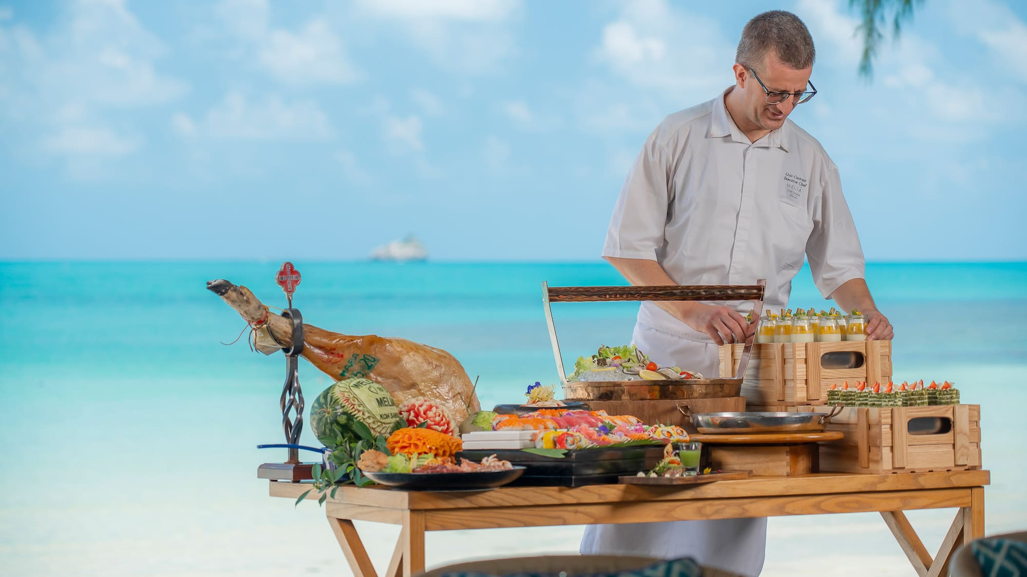 a man standing at a table with food on it