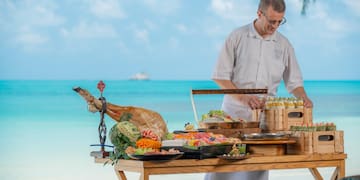 a man standing at a table with food on it