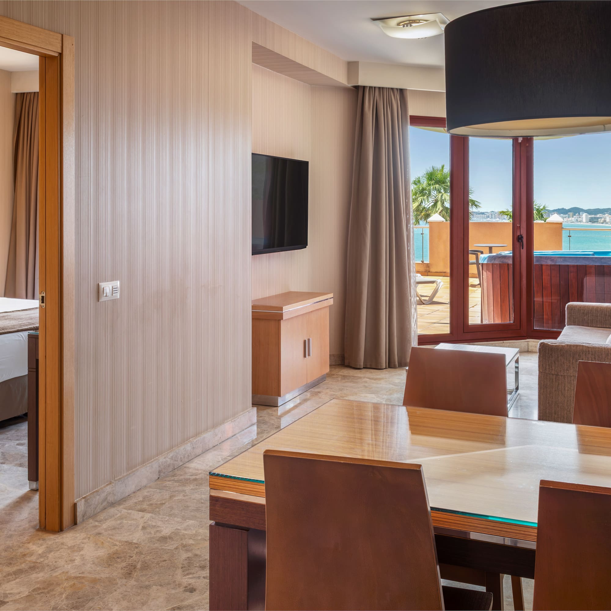 Hotel suite living room, bedroom, hot tub balcony, ocean view.