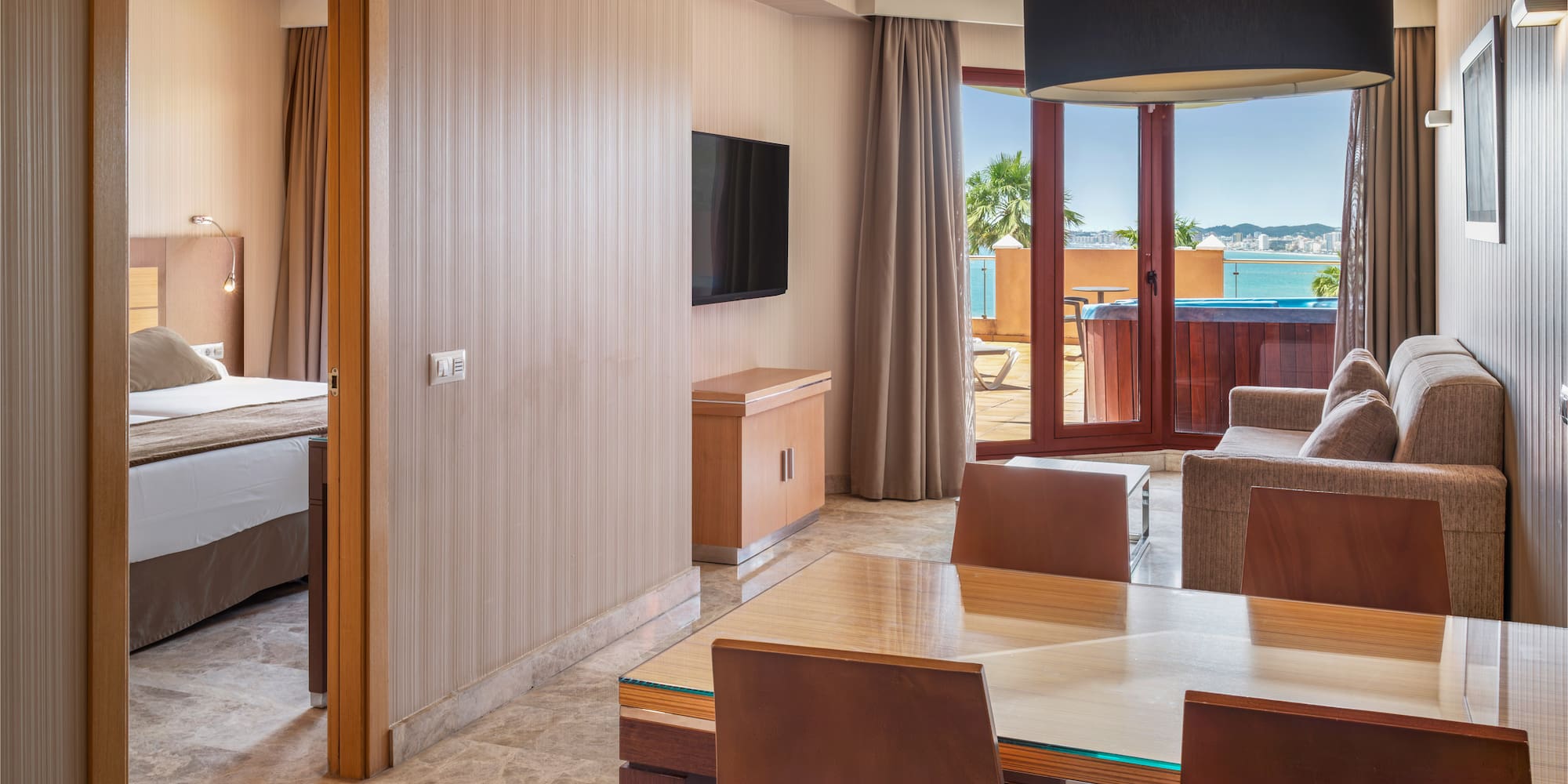 Hotel suite living room, bedroom, hot tub balcony, ocean view.
