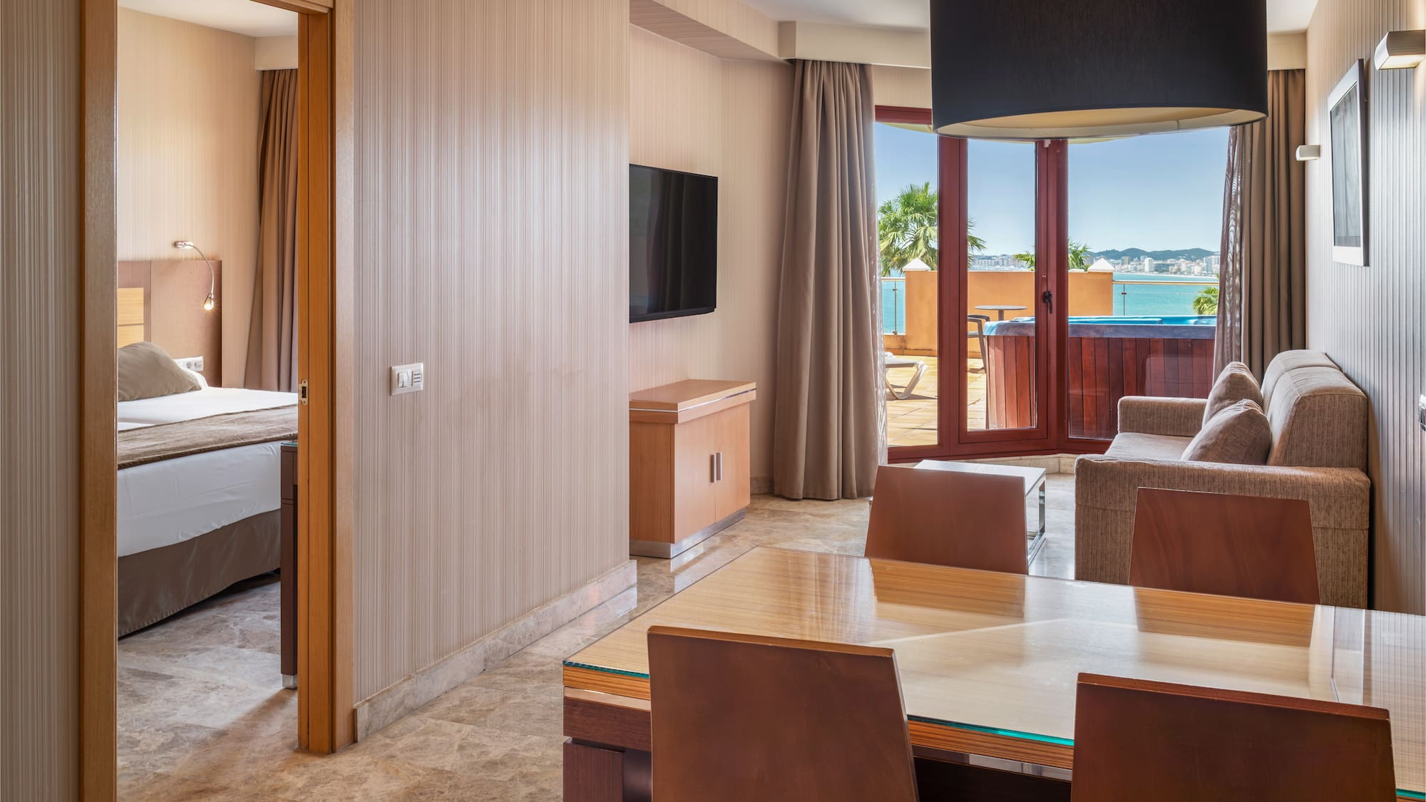 Hotel suite living room, bedroom, hot tub balcony, ocean view.
