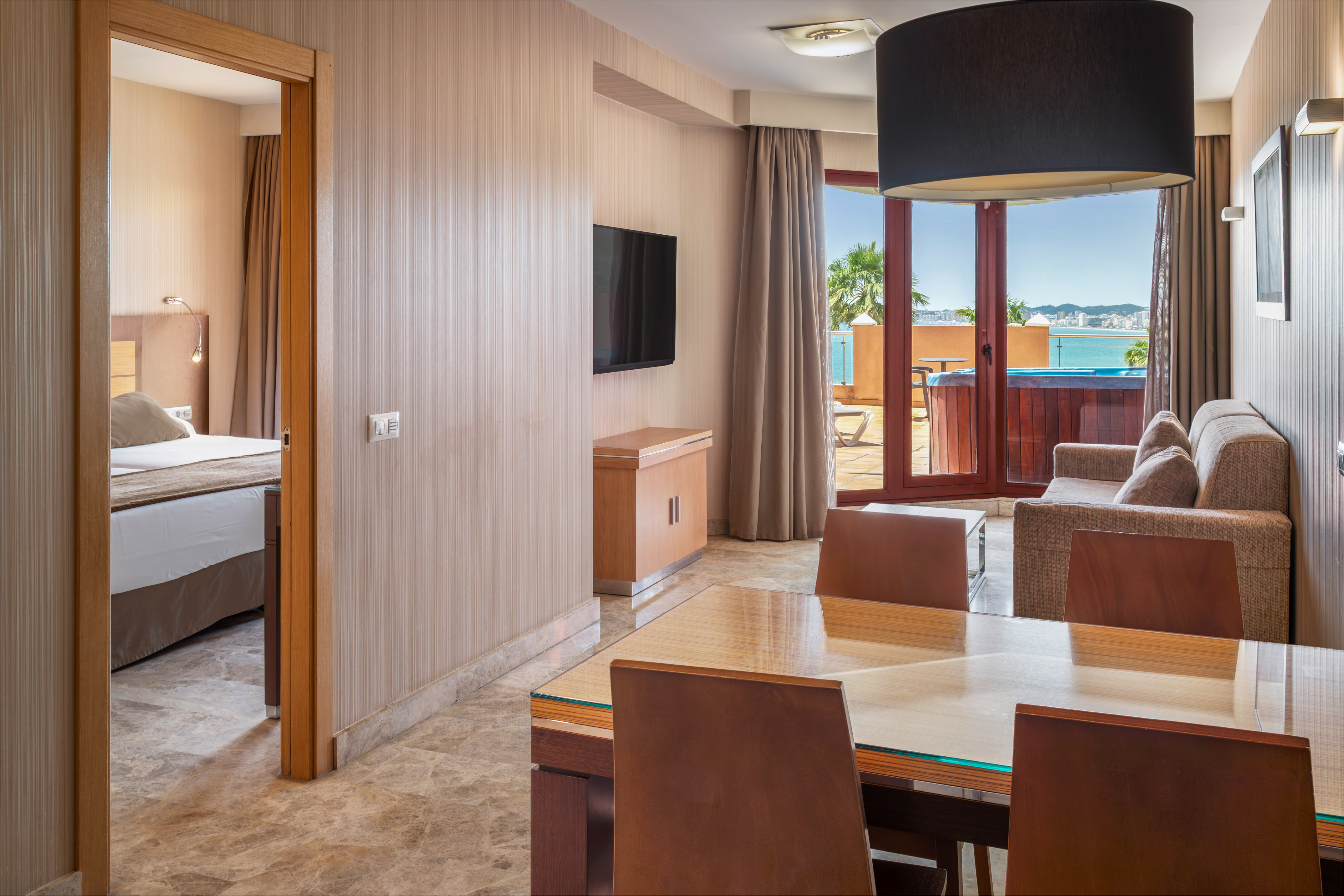Hotel suite living room, bedroom, hot tub balcony, ocean view.