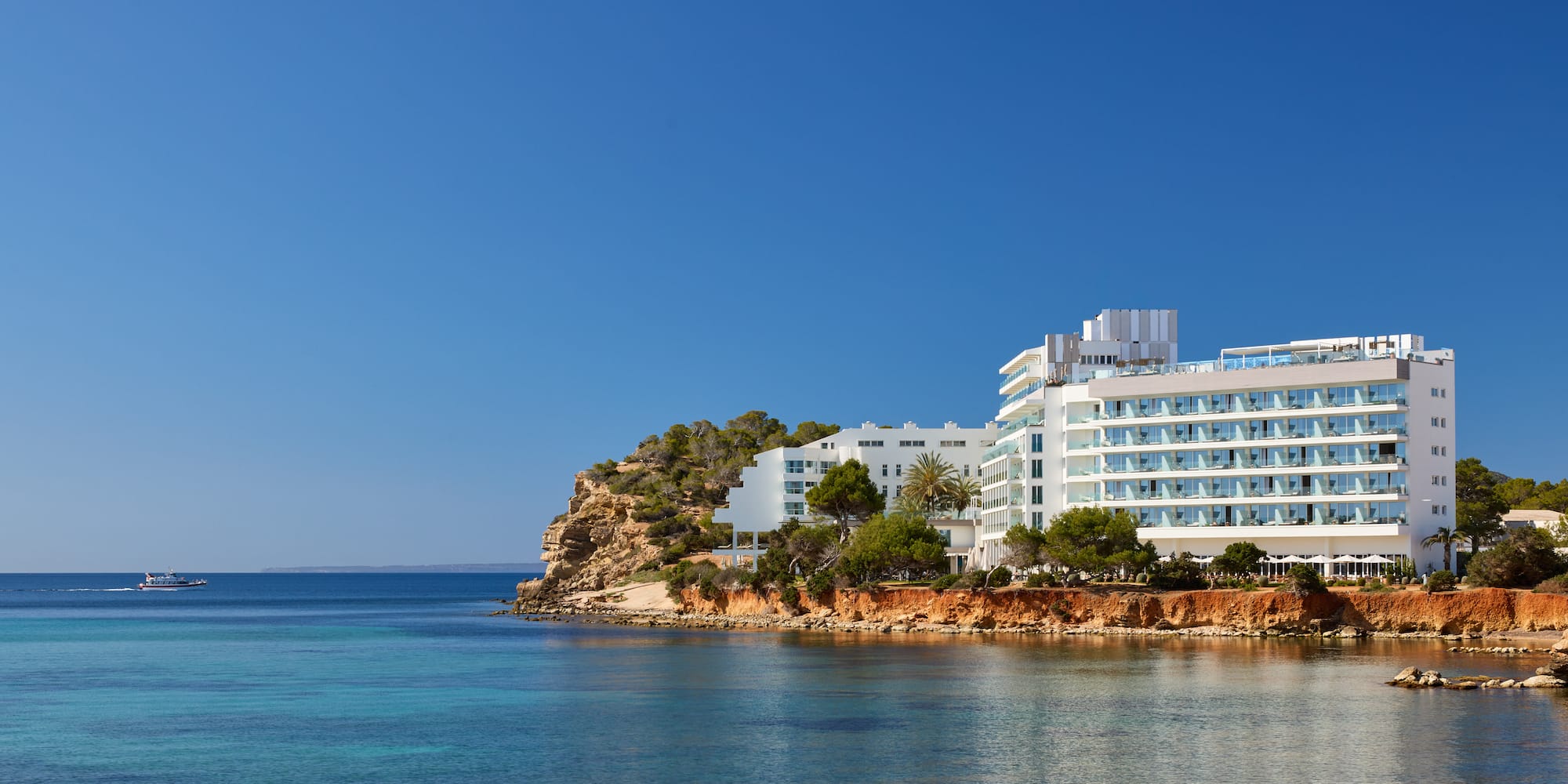 a white building next to a body of water