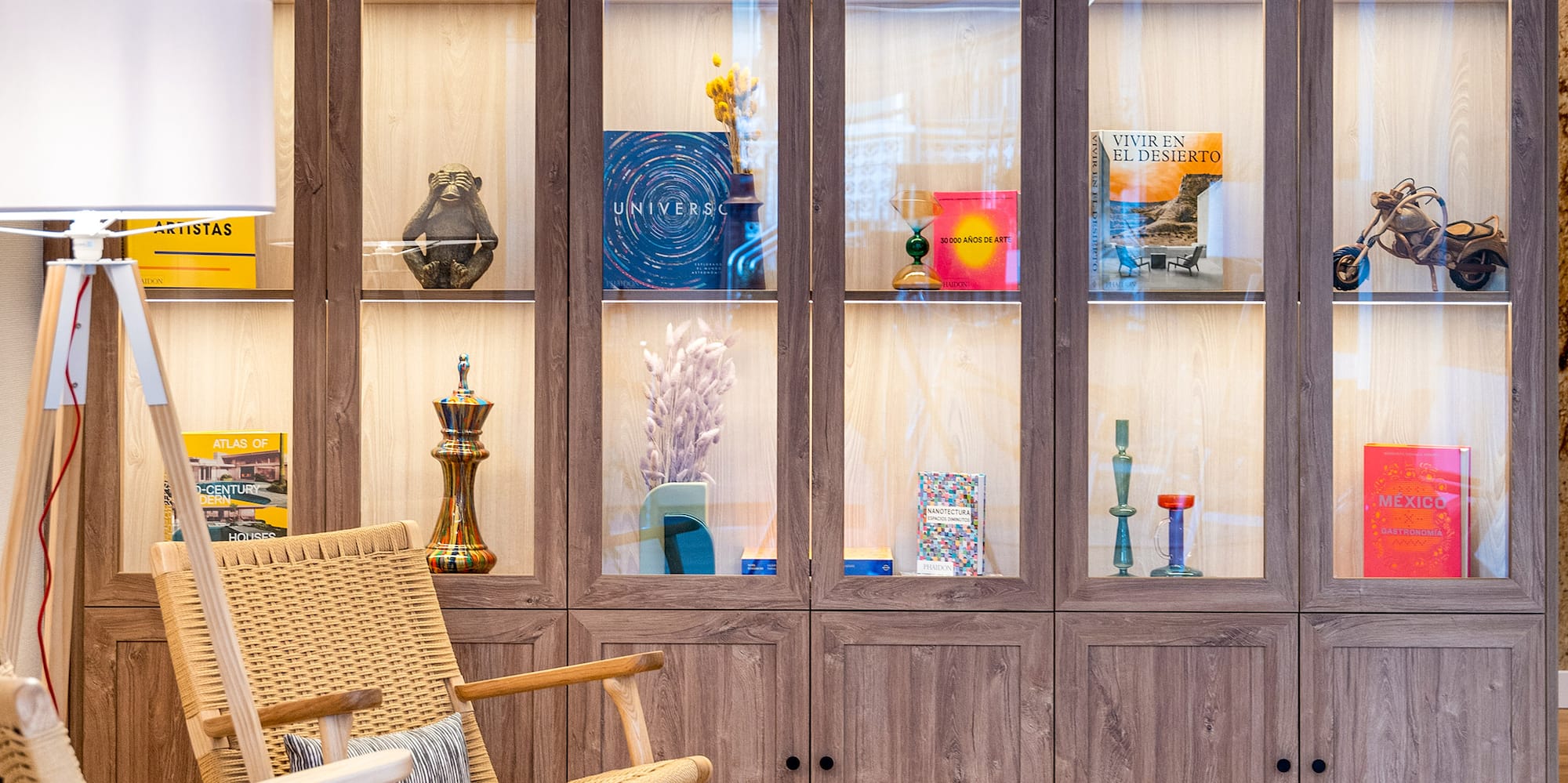 a chair in front of a glass cabinet