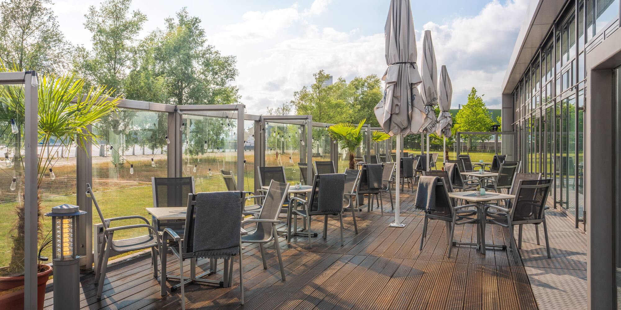 a patio with chairs and umbrellas