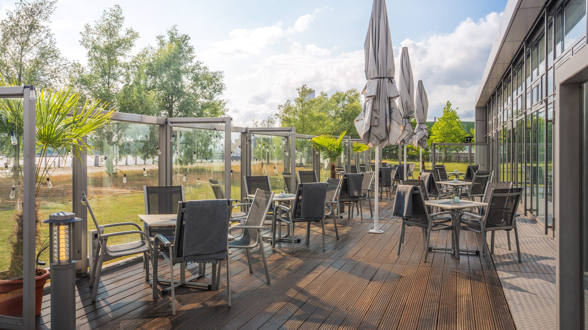 a patio with chairs and umbrellas