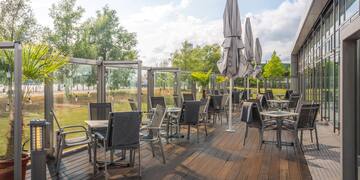 a patio with chairs and umbrellas