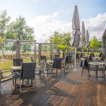 a patio with chairs and umbrellas