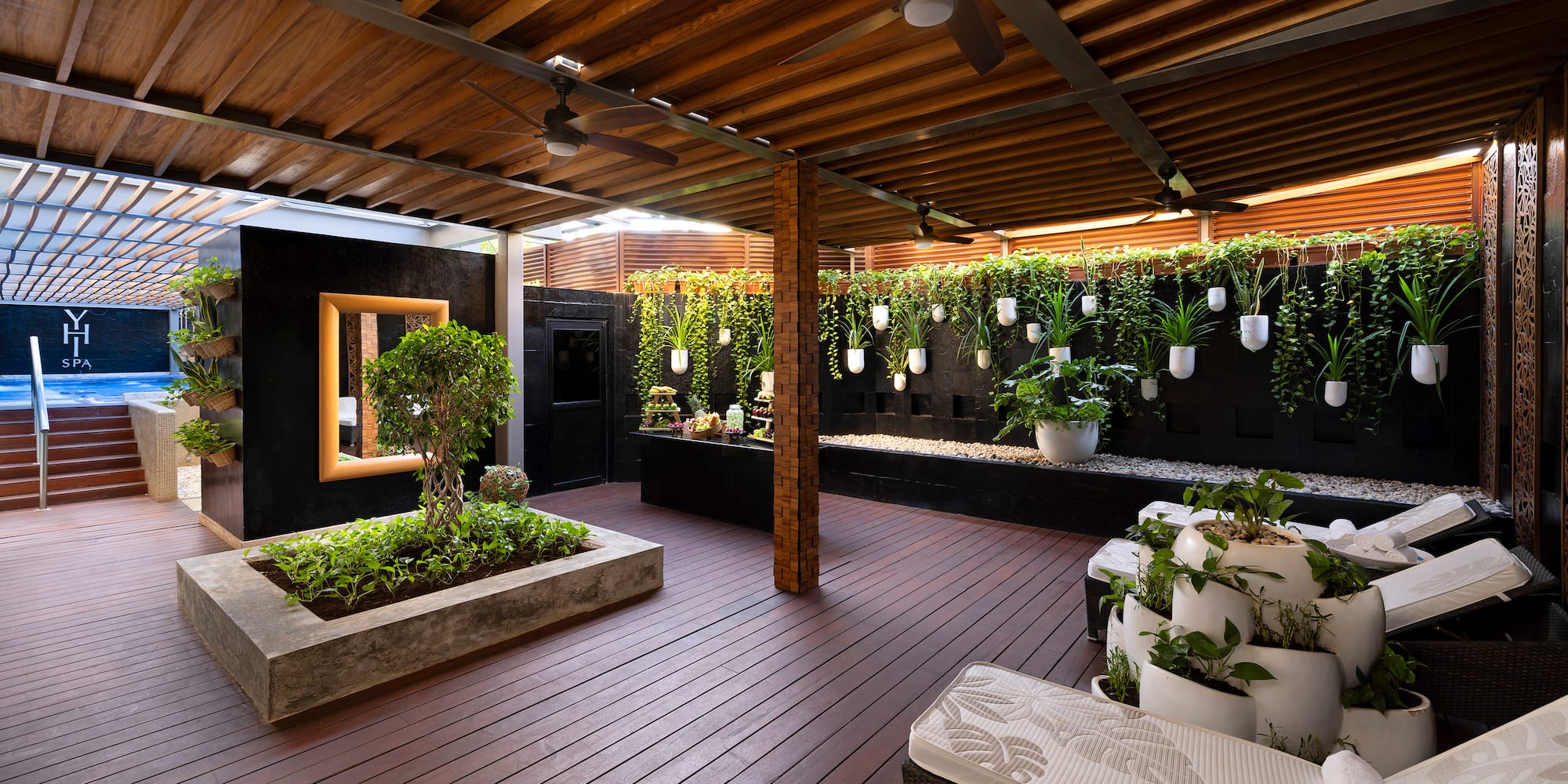 a patio with plants and a ceiling fan