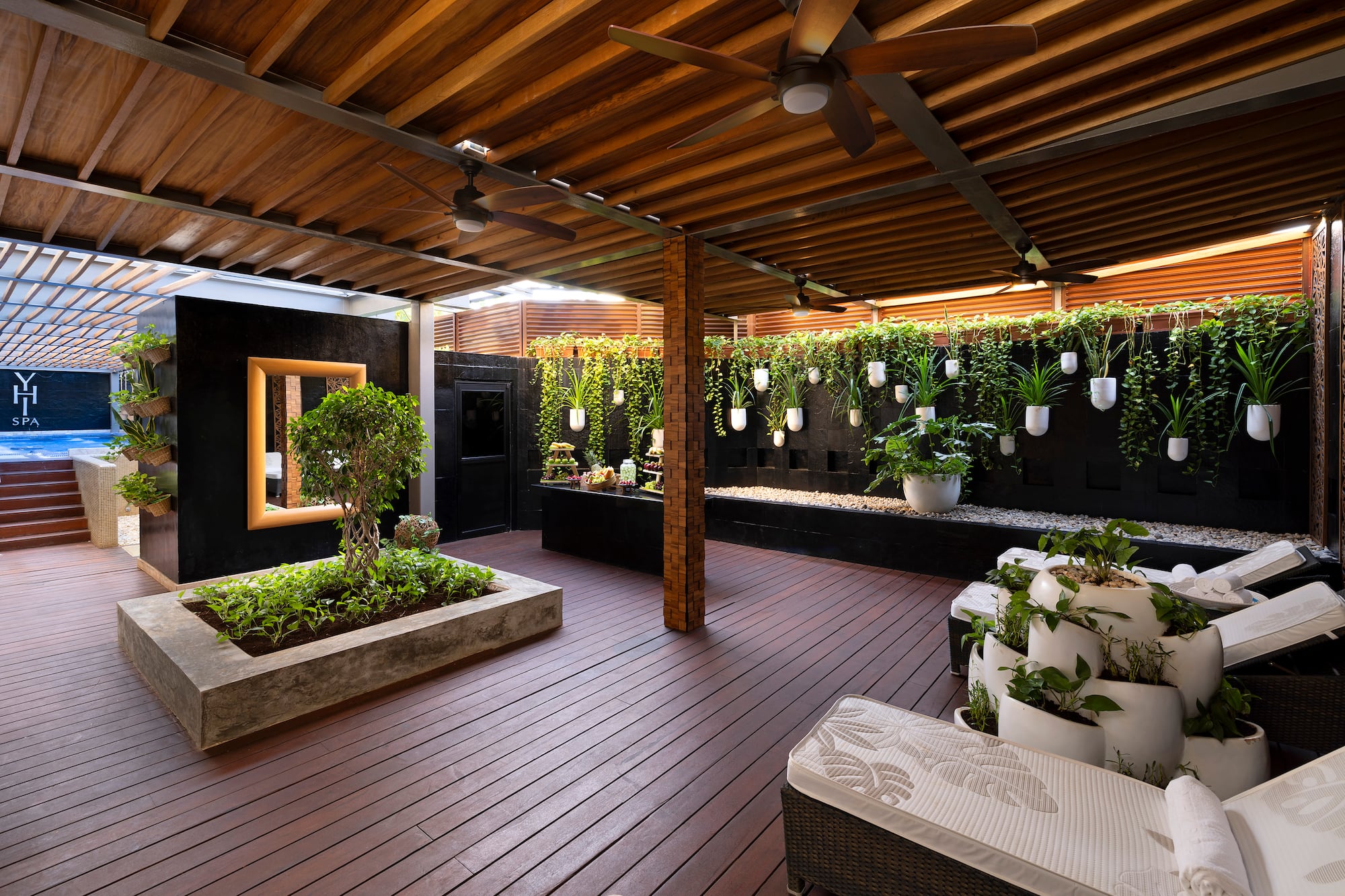 a patio with plants and a ceiling fan