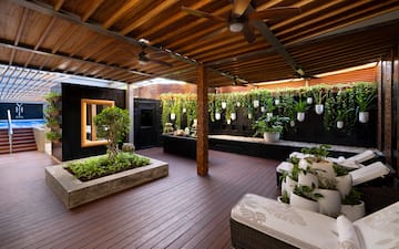 a patio with plants and a ceiling fan