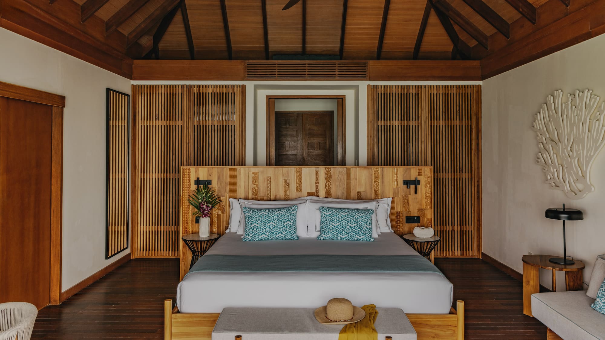 a deck with chairs and a table overlooking the ocean