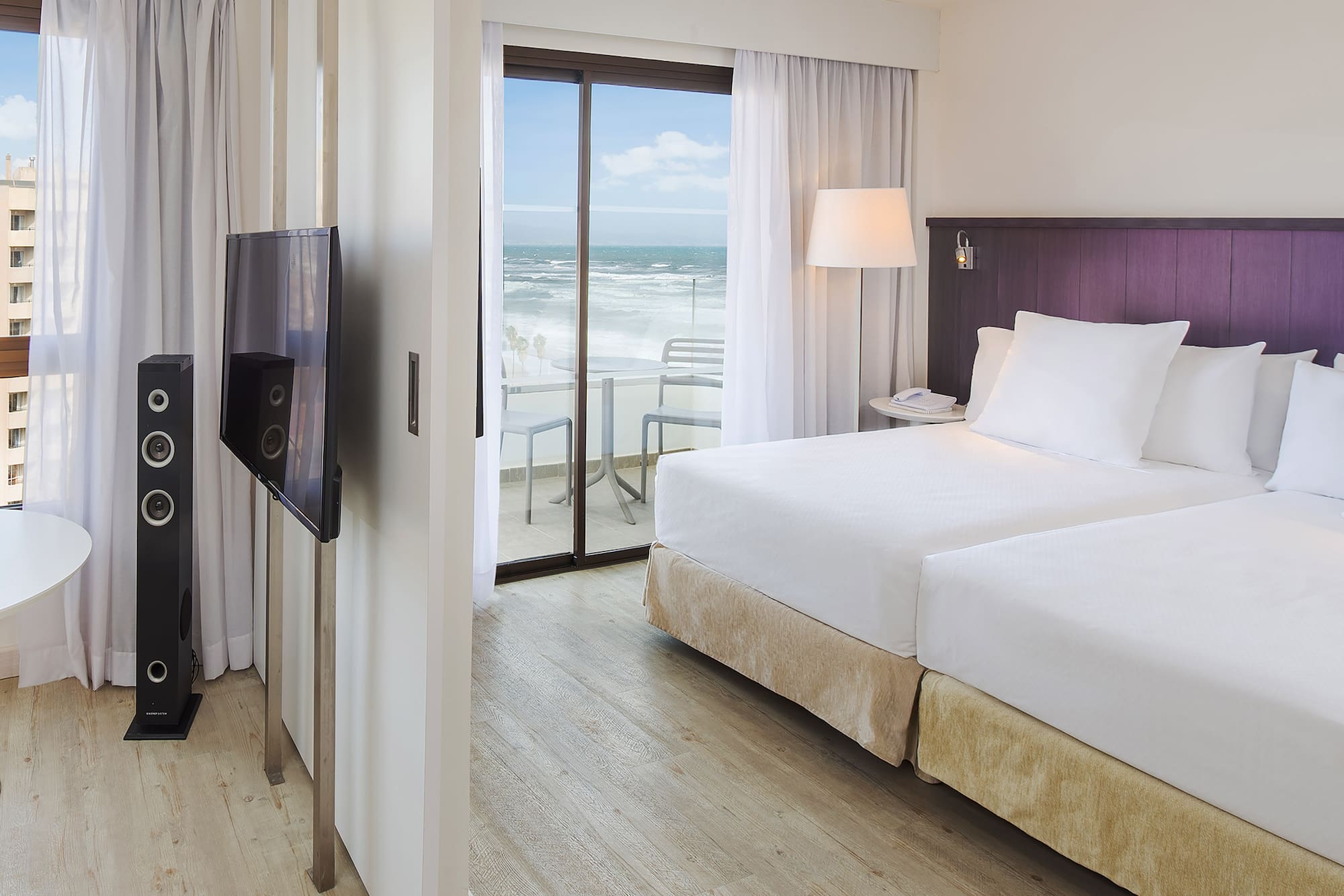 a room with a television and a large bed