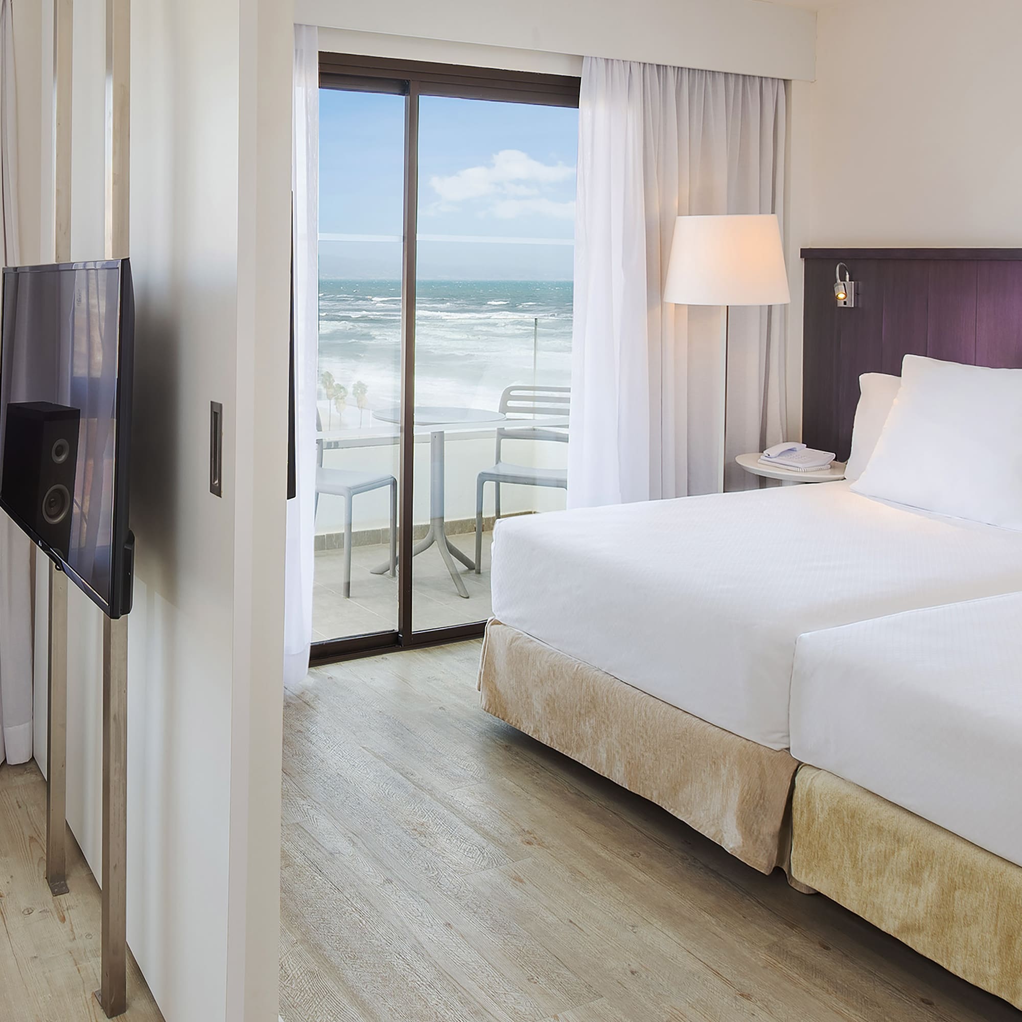 a room with a television and a large bed