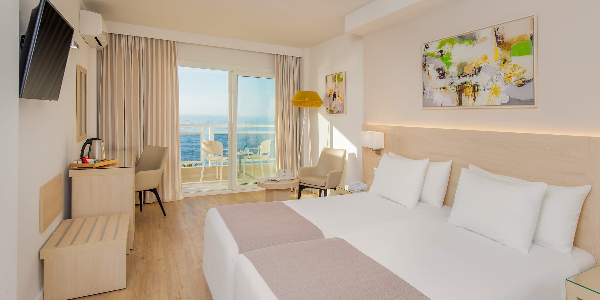 a room with two beds and a glass door