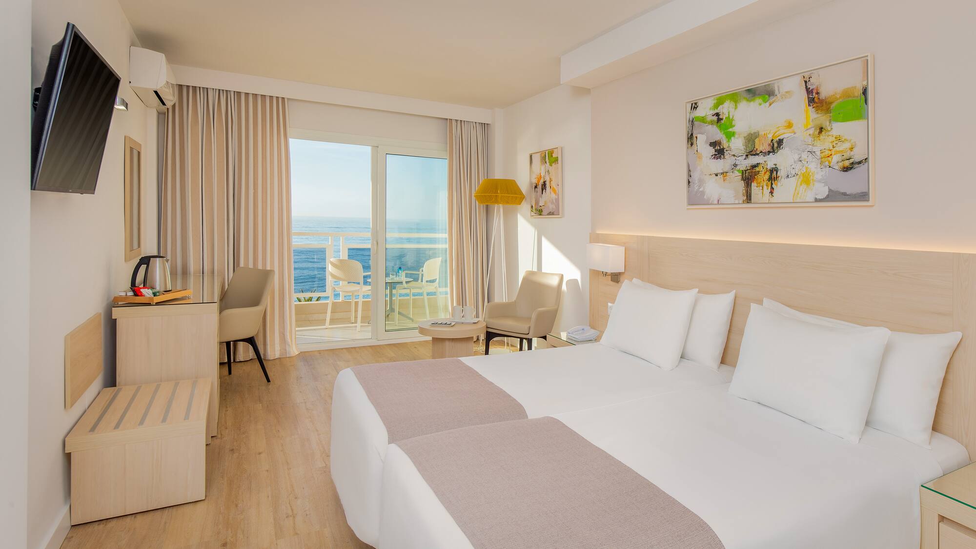 a room with two beds and a glass door