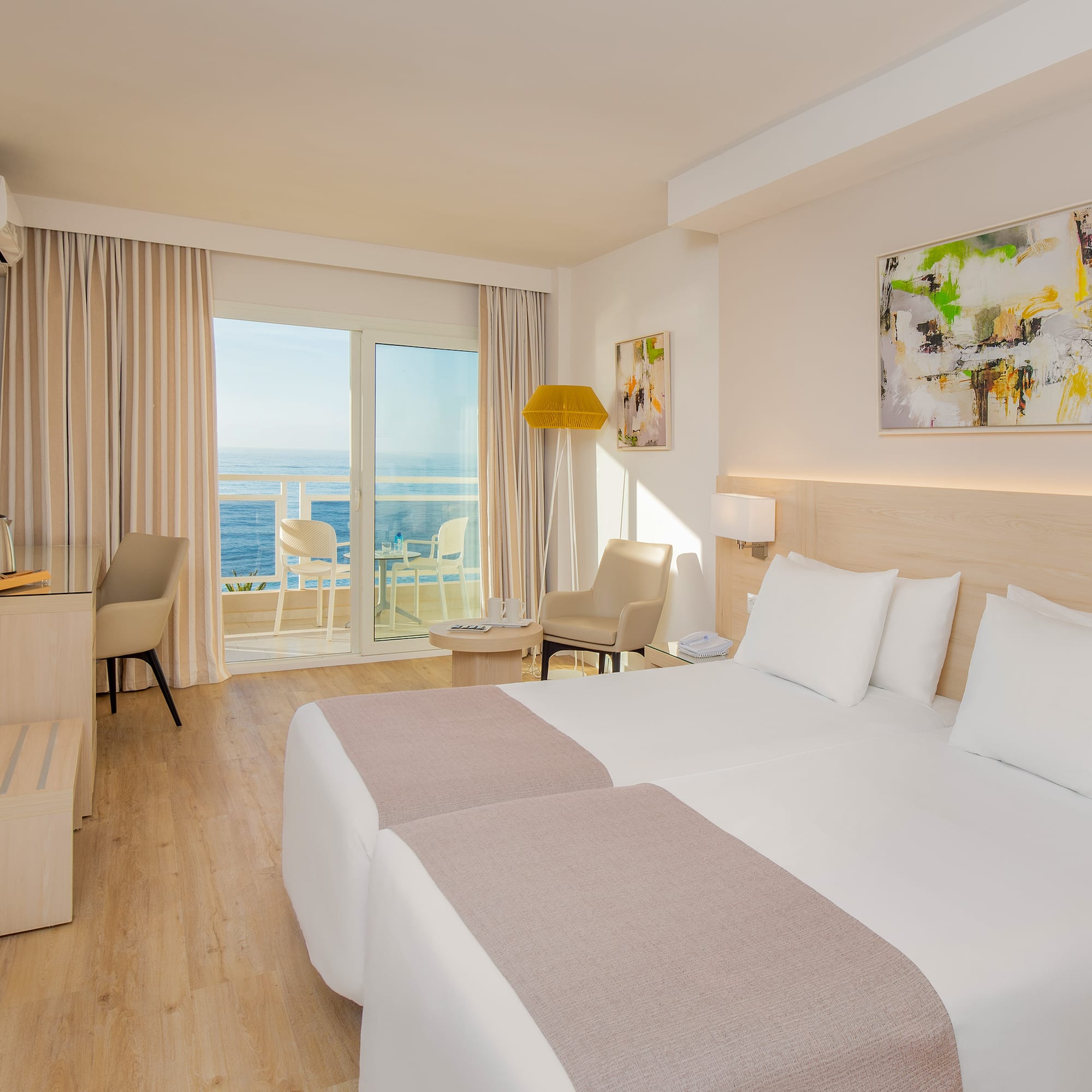 a room with two beds and a glass door