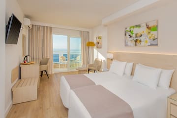 a room with two beds and a glass door