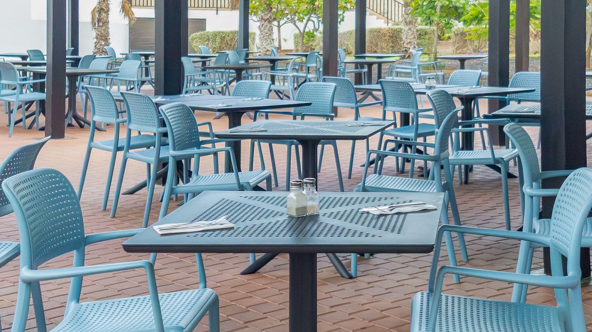 a patio with tables and chairs