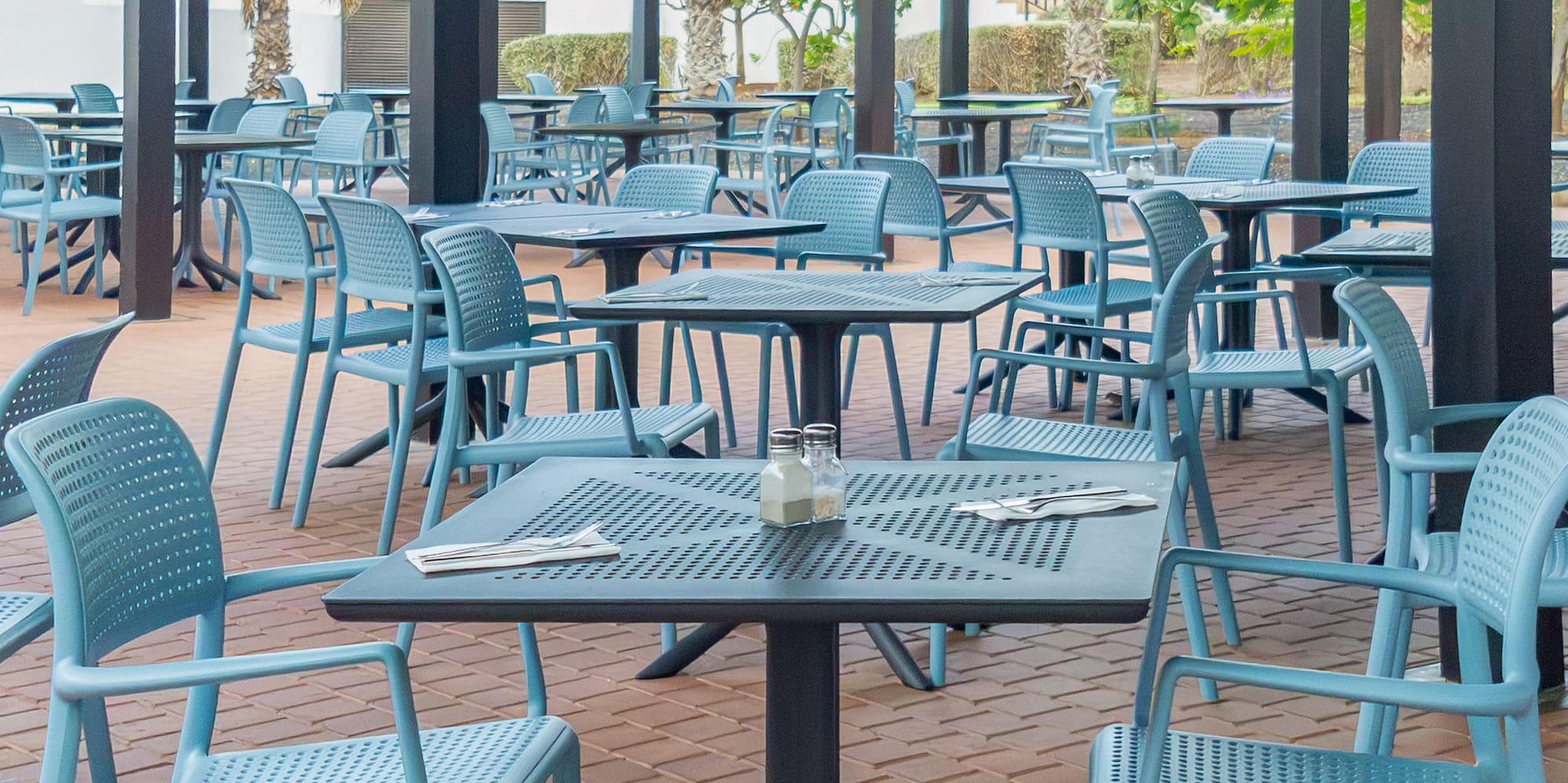a patio with tables and chairs