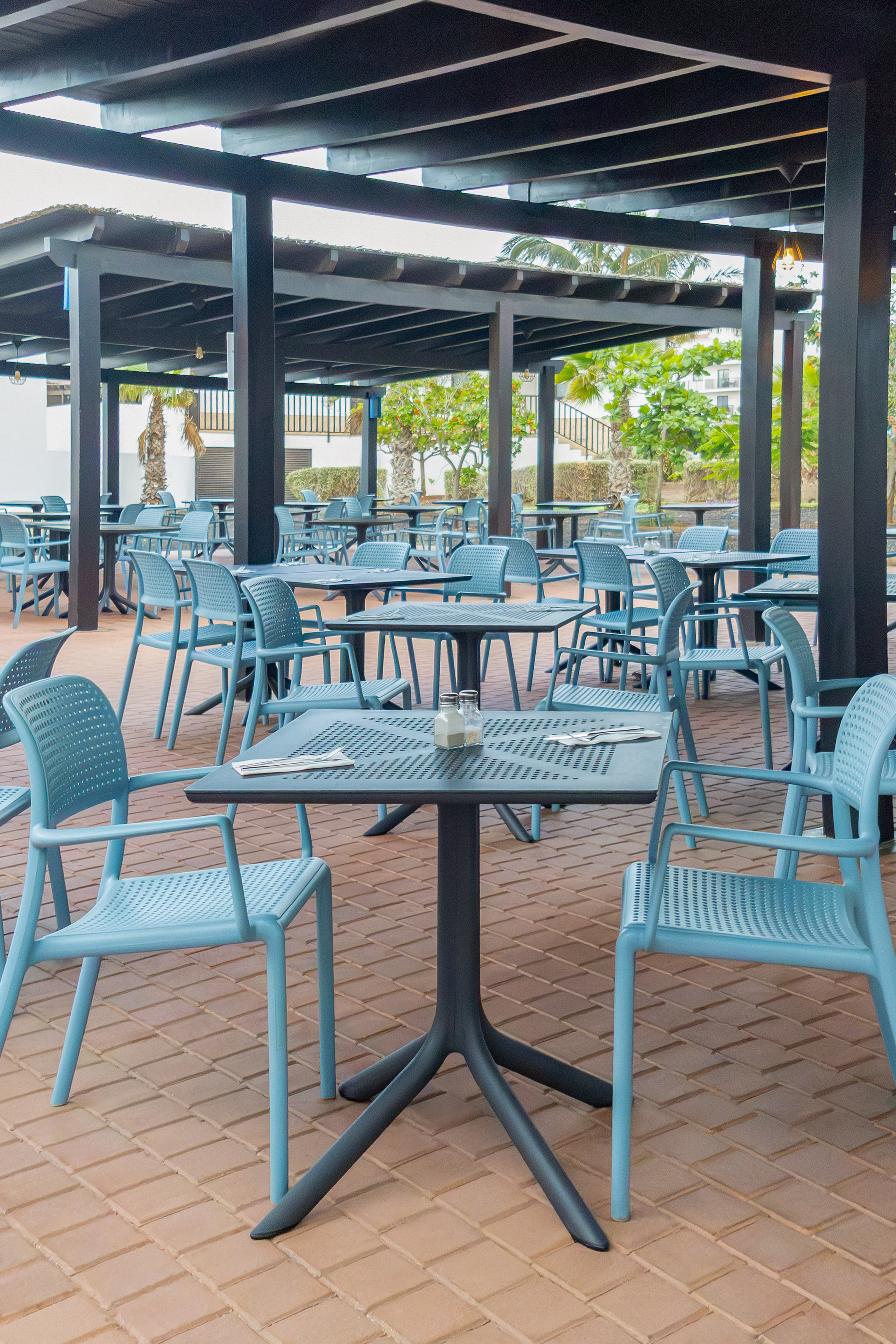 a patio with tables and chairs