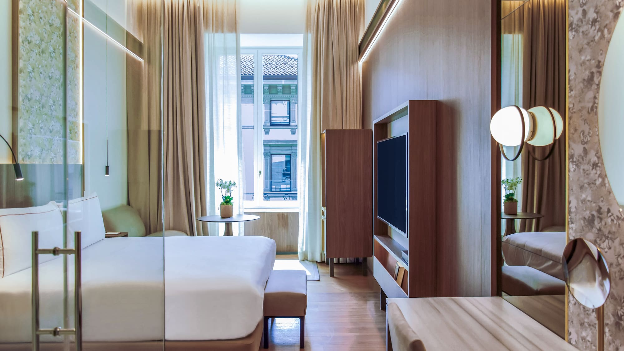 City Views from the Deluxe room with a bed and a television at Palazzo Cordusio Gran Melia Hotel