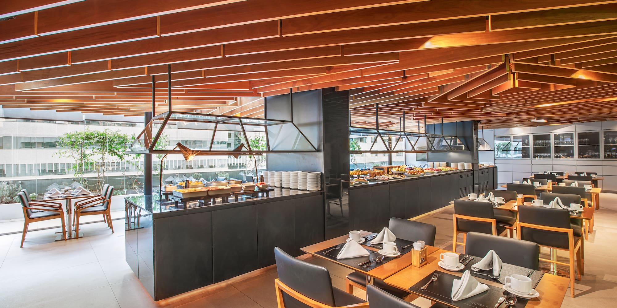 a restaurant with a large counter and tables