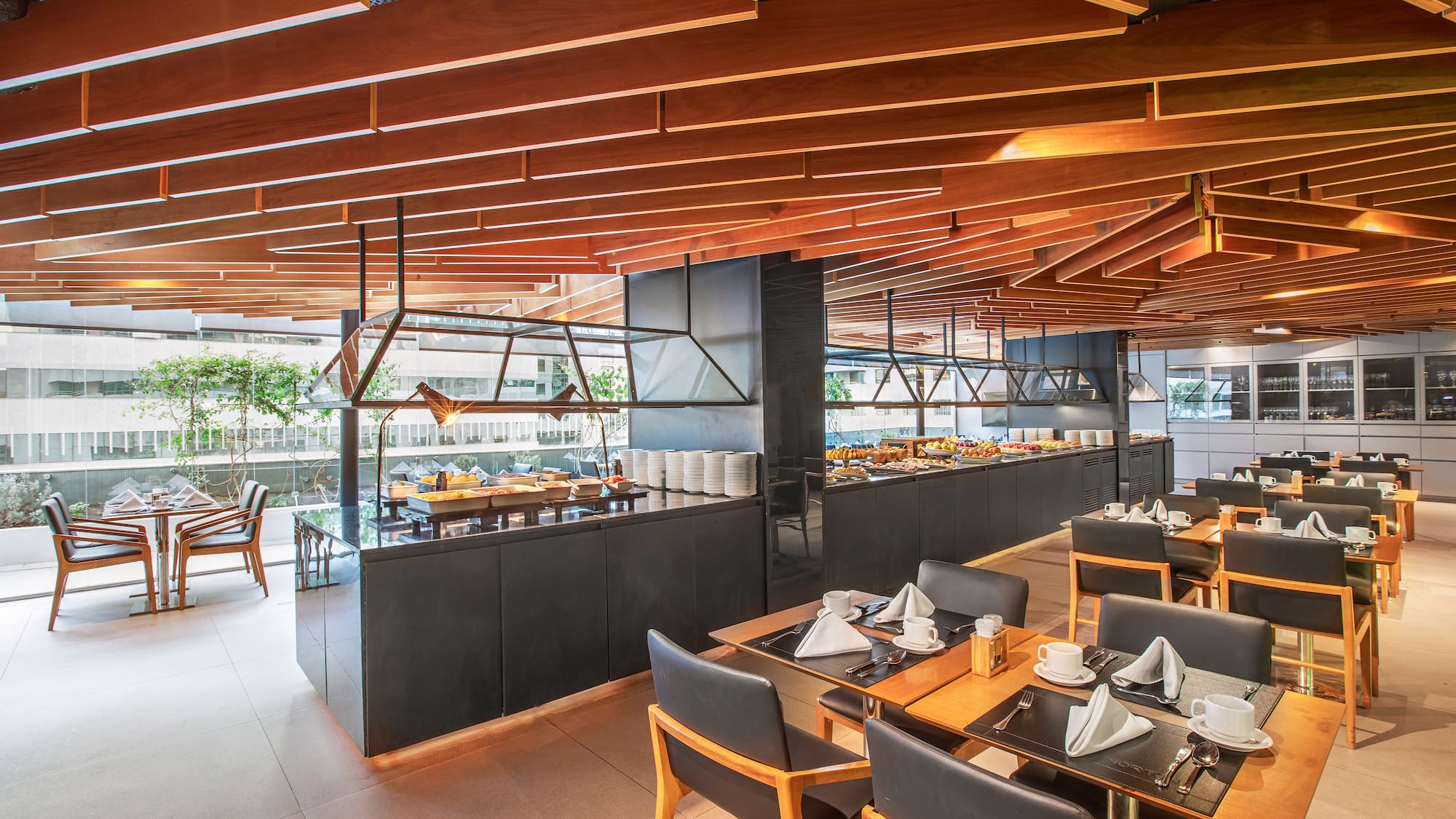 a restaurant with a large counter and tables