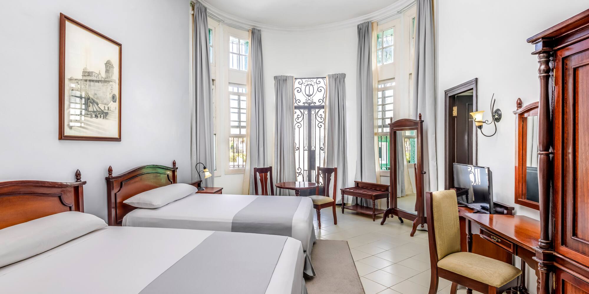 a room with two beds and a computer