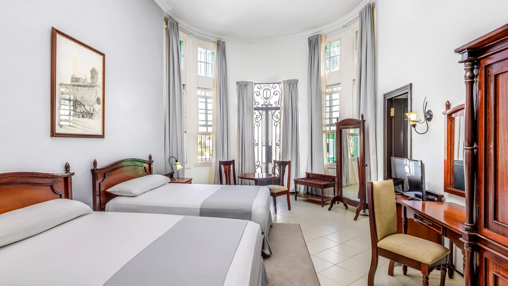 a room with two beds and a computer