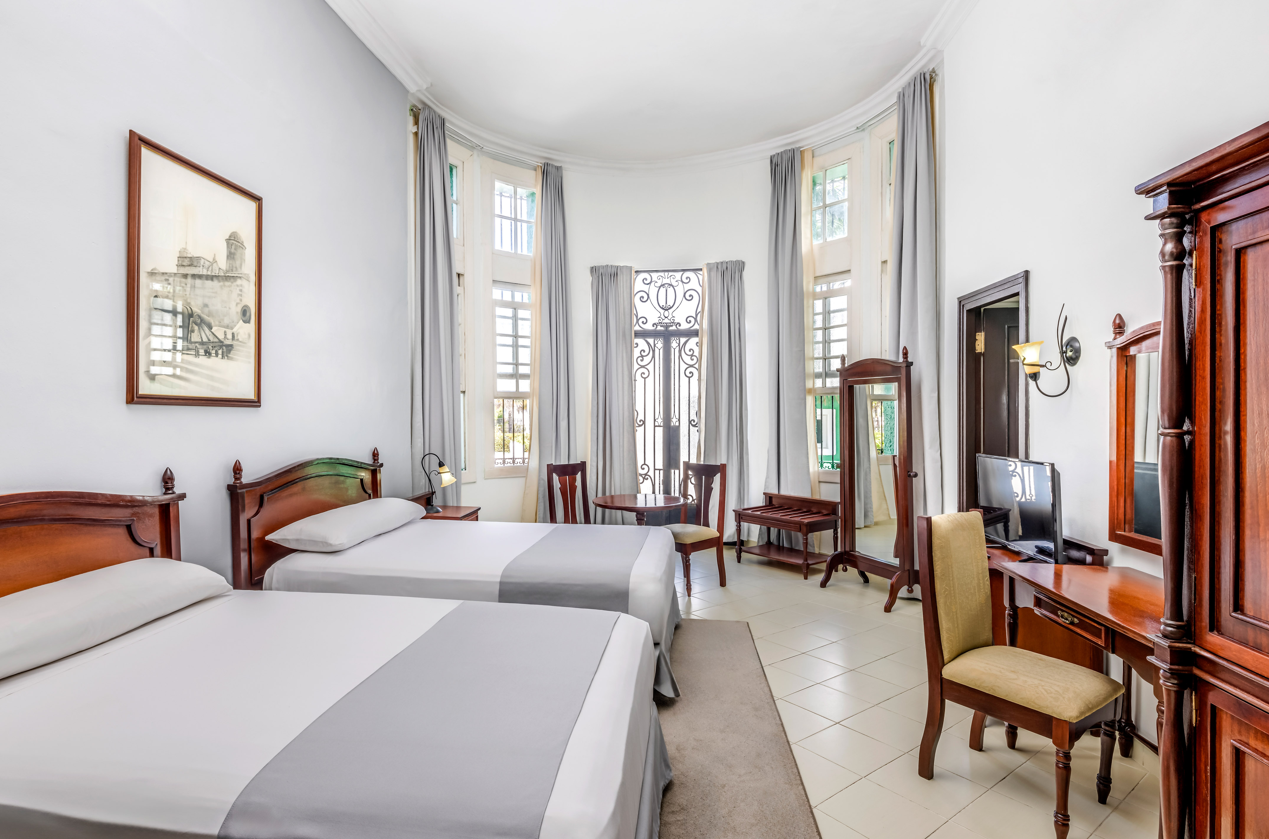 a room with two beds and a computer