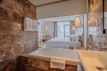 a bathroom with a bed and a bathtub