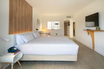 a bedroom with a bed and a tv