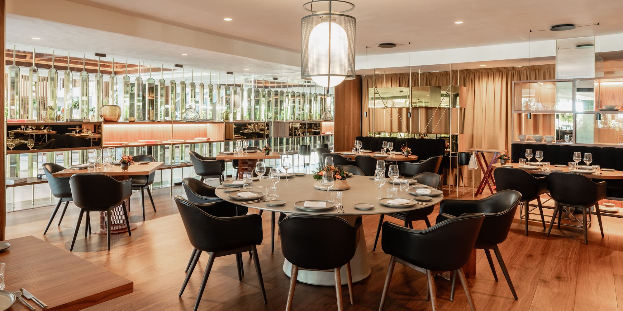 a room with a large round table and chairs