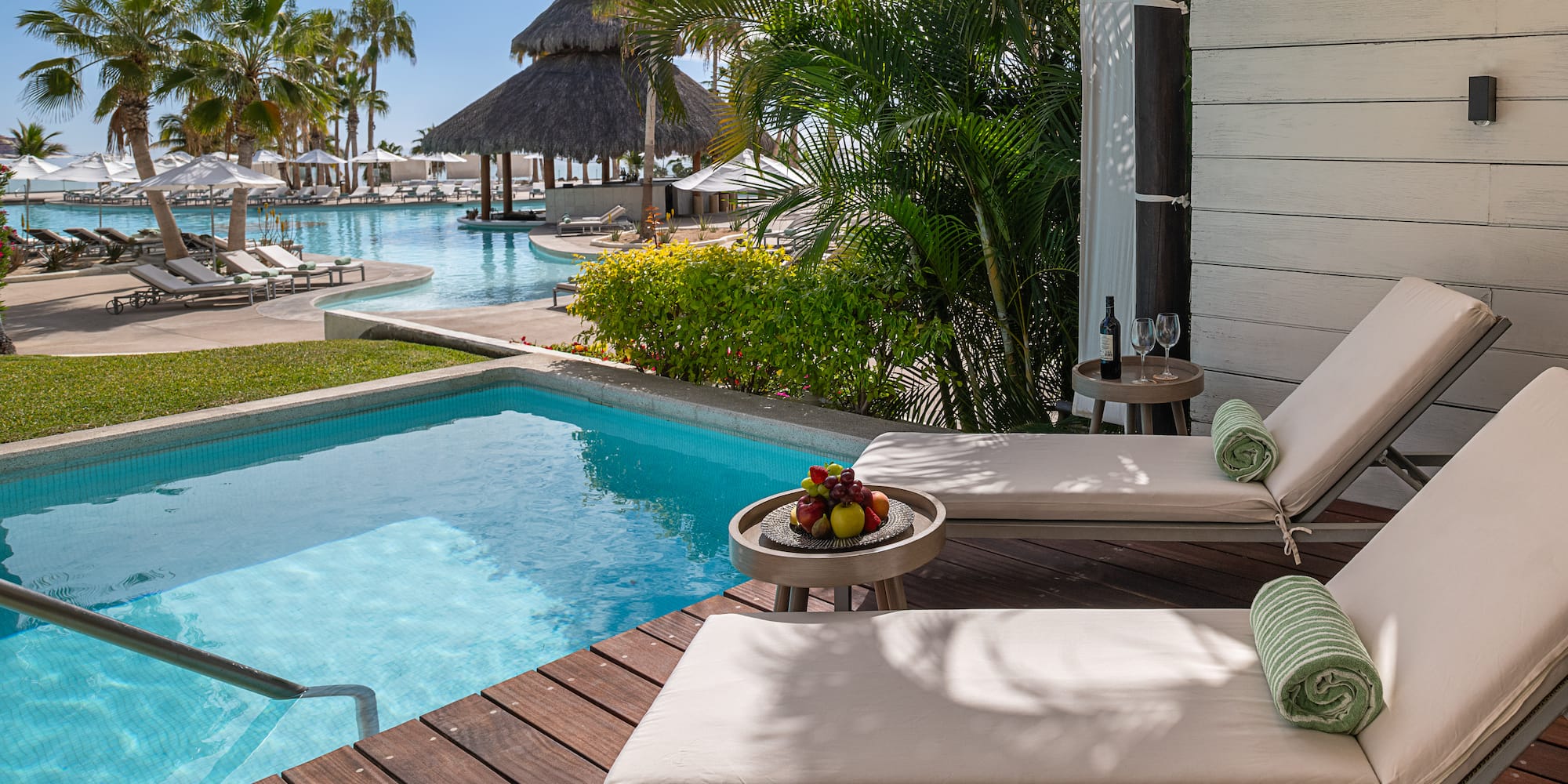 a pool with lounge chairs and a table