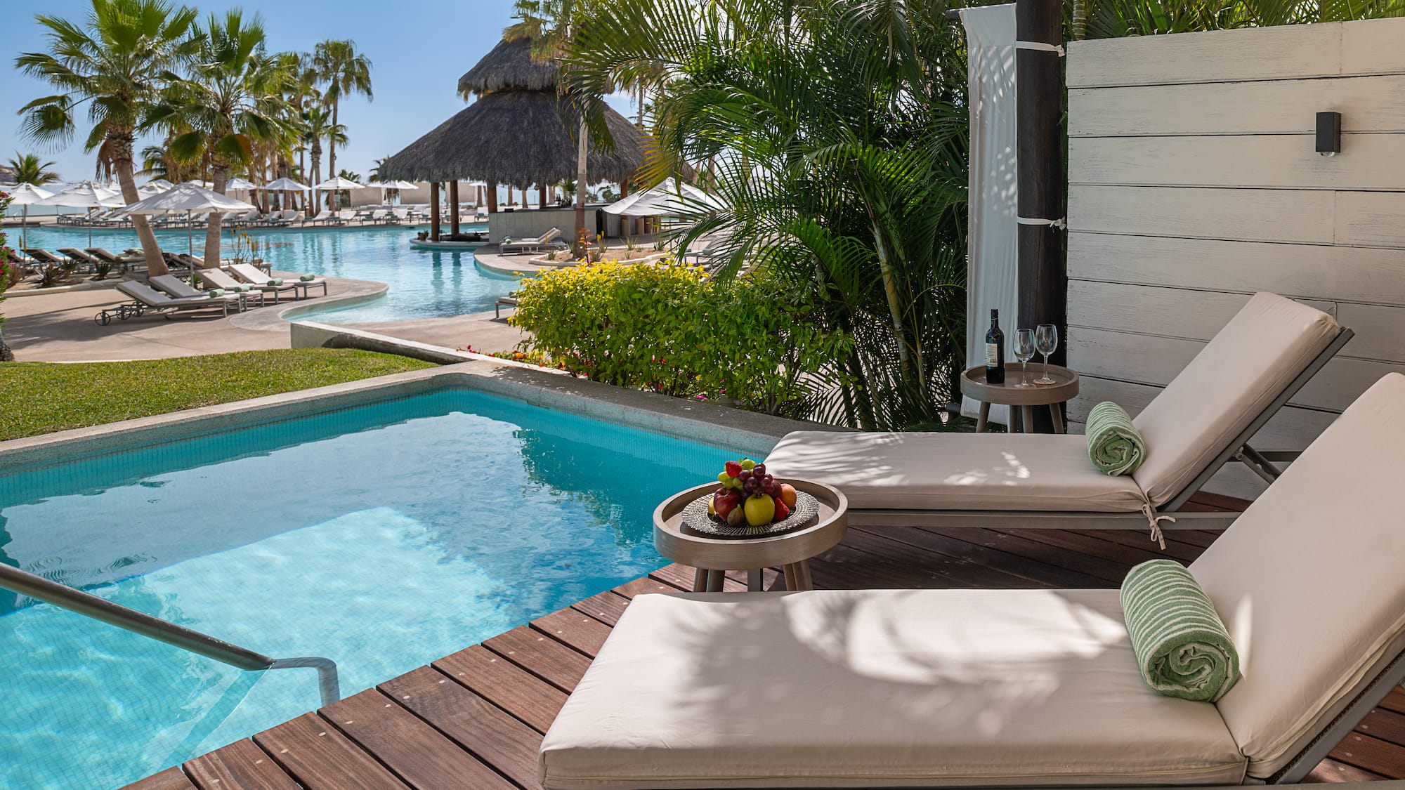 a pool with lounge chairs and a table