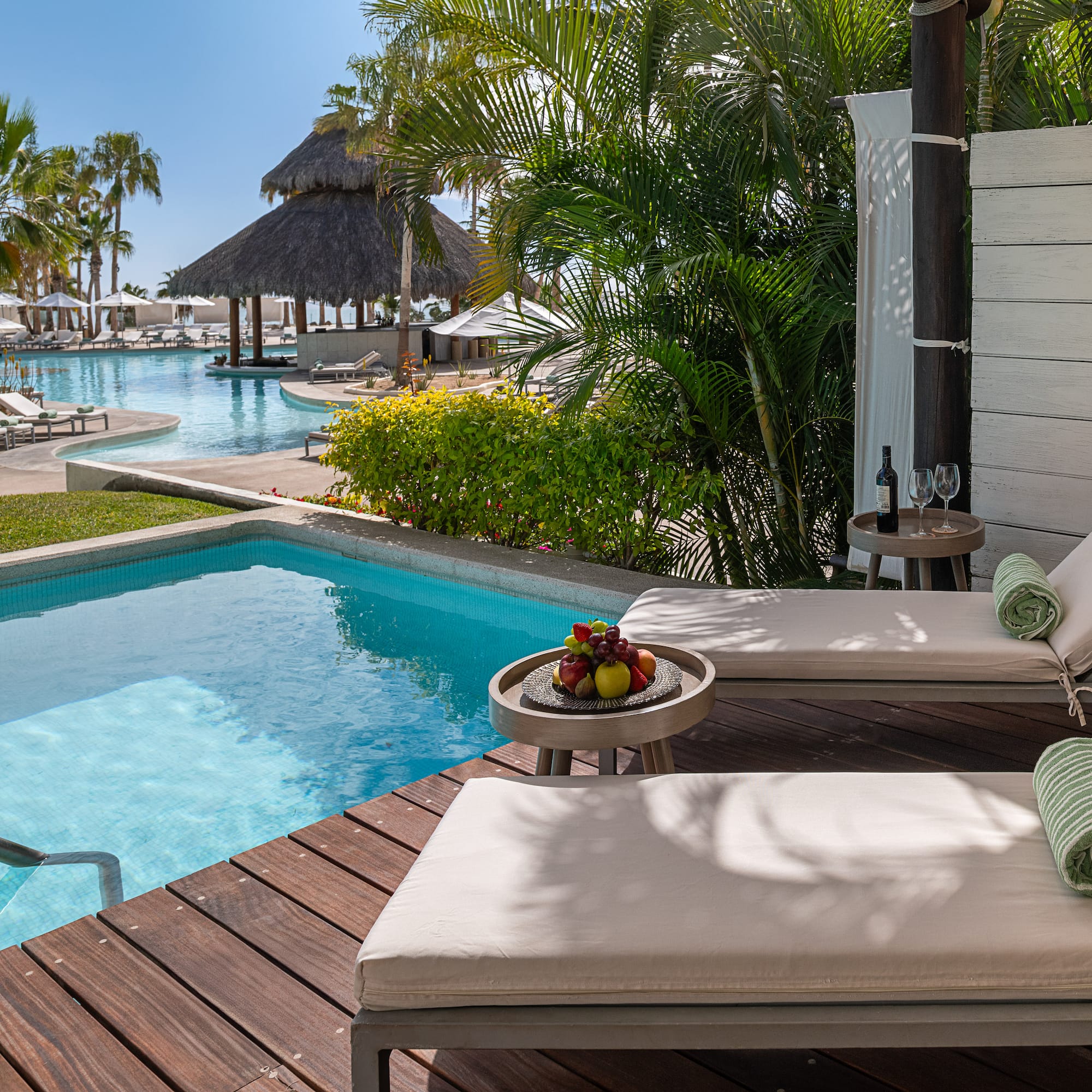 a pool with lounge chairs and a table
