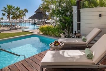 a pool with lounge chairs and a table