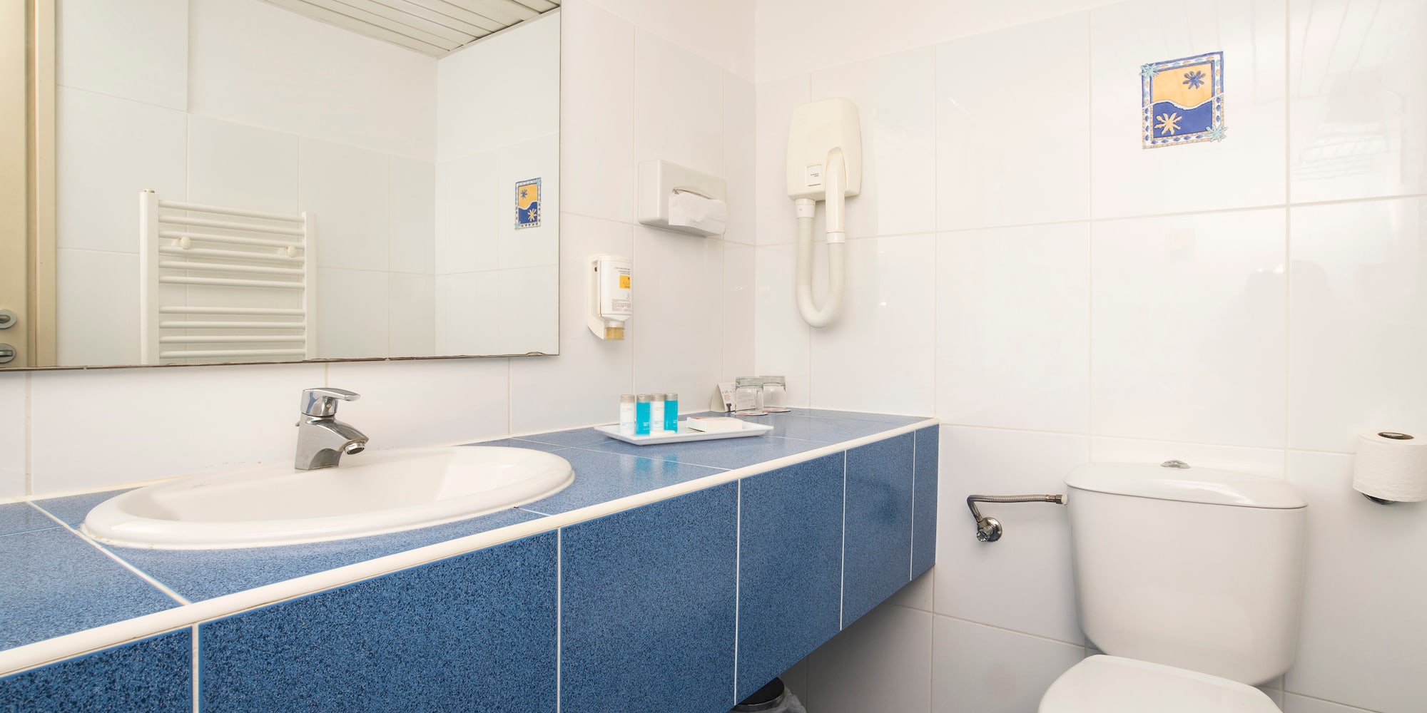 a bathroom with a blue countertop and a toilet