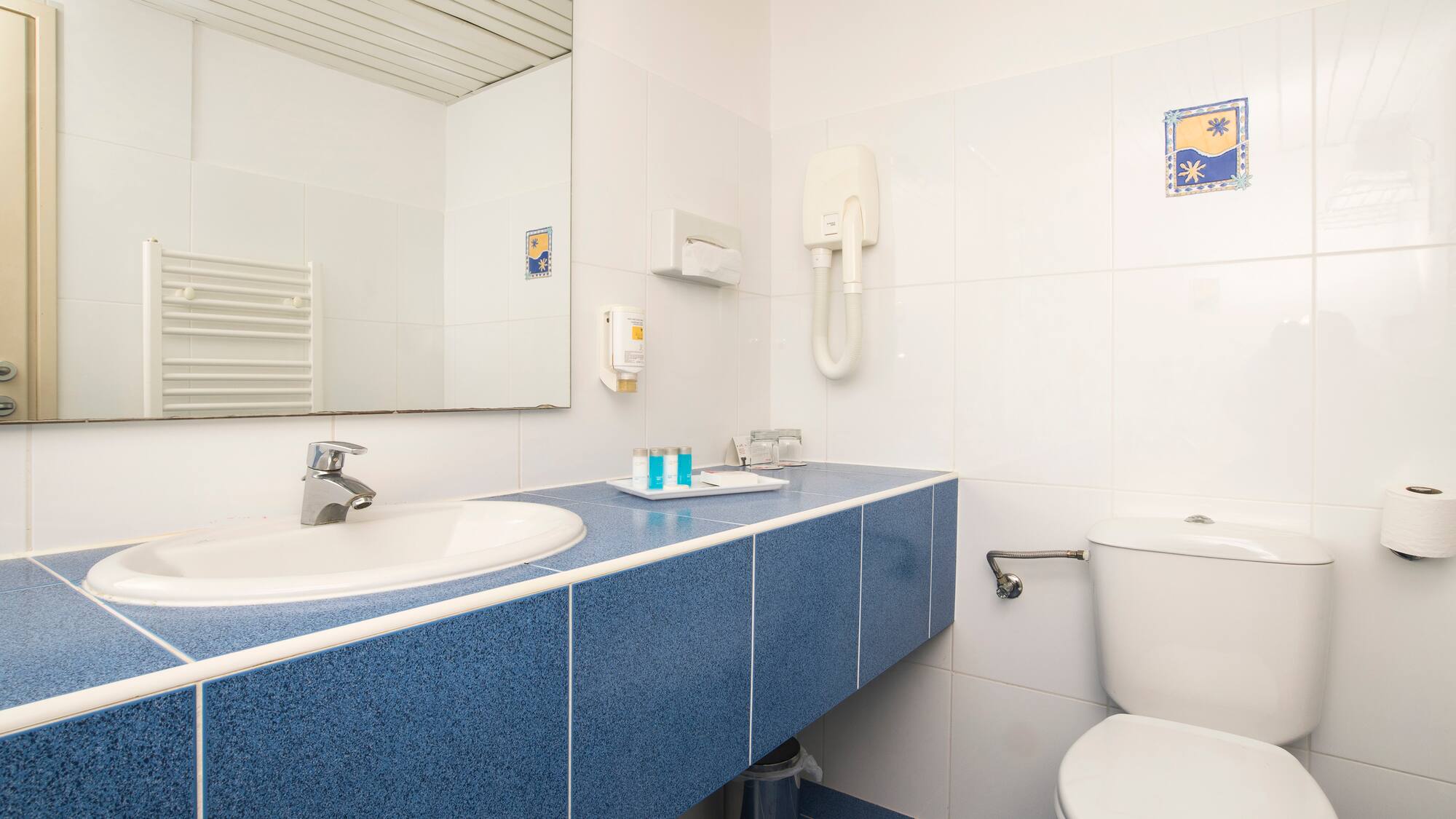 a bathroom with a blue countertop and a toilet