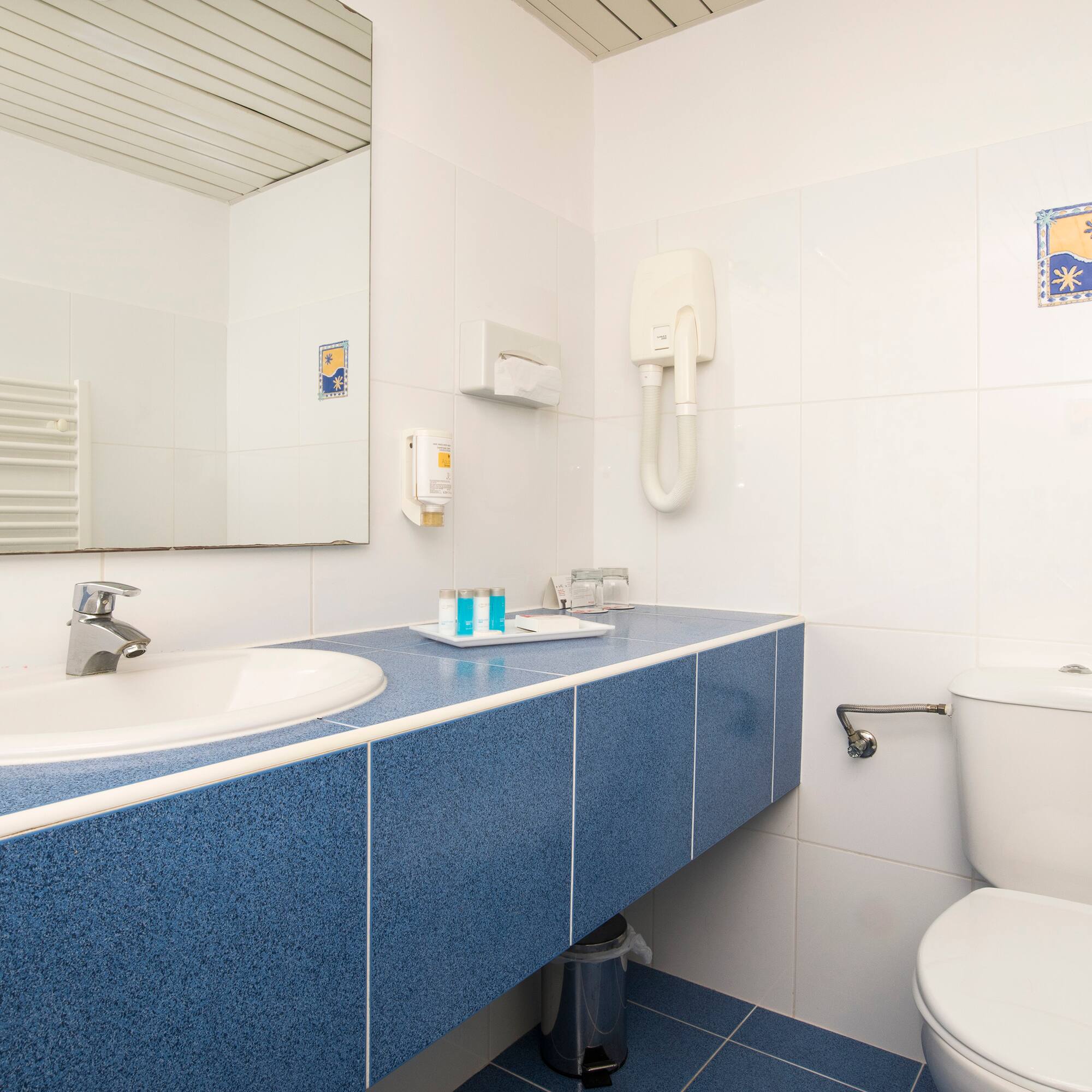 a bathroom with a blue countertop and a toilet