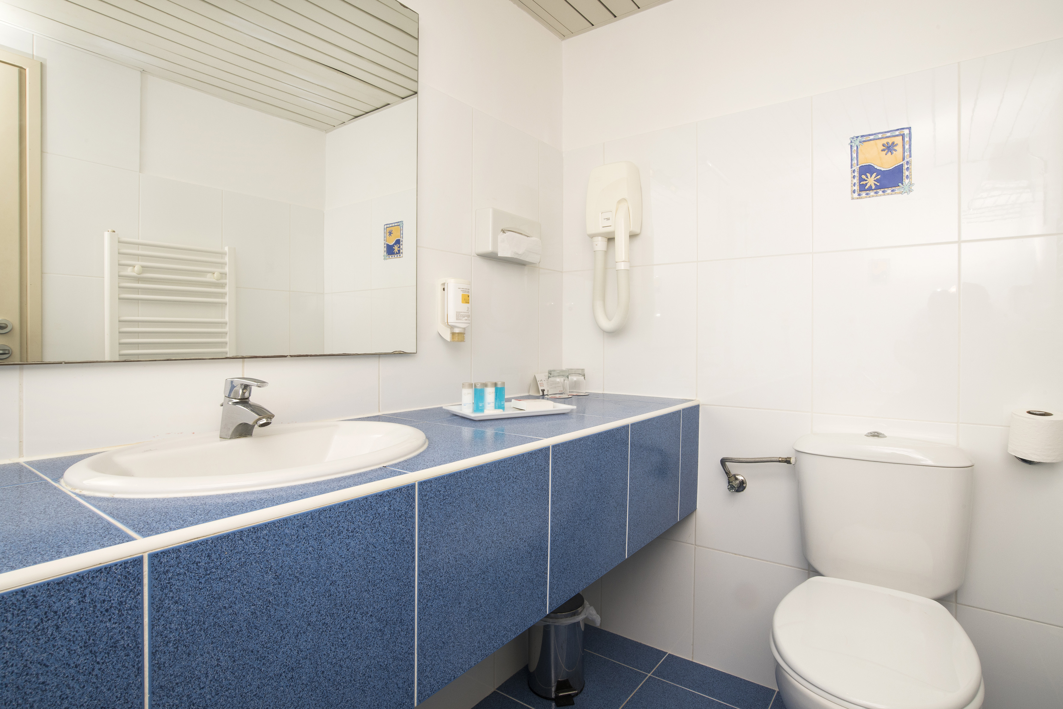 a bathroom with a blue countertop and a toilet