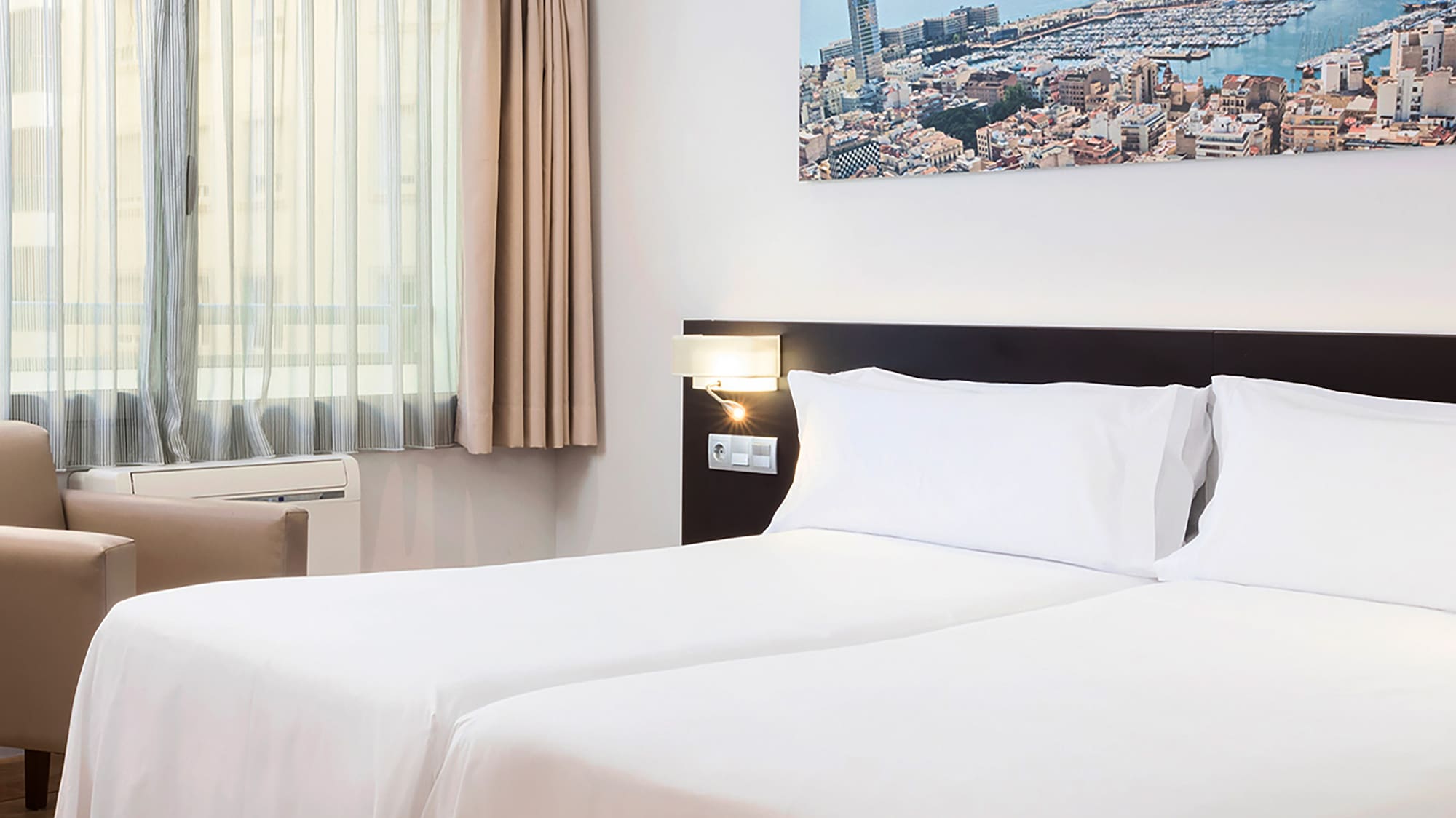 a room with two beds and a chair