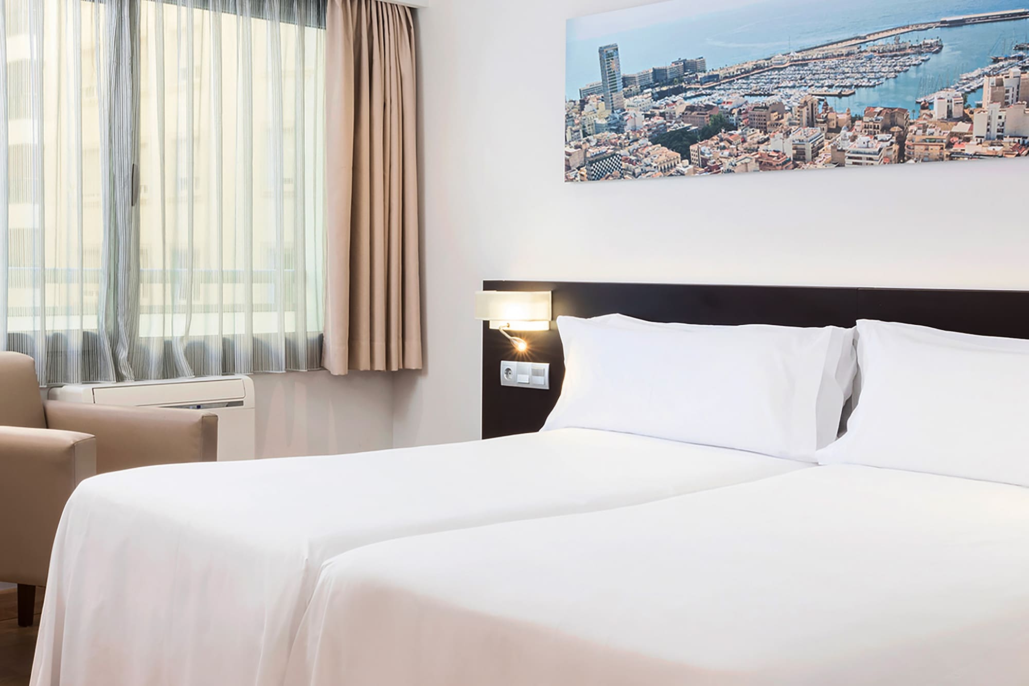 a room with two beds and a chair